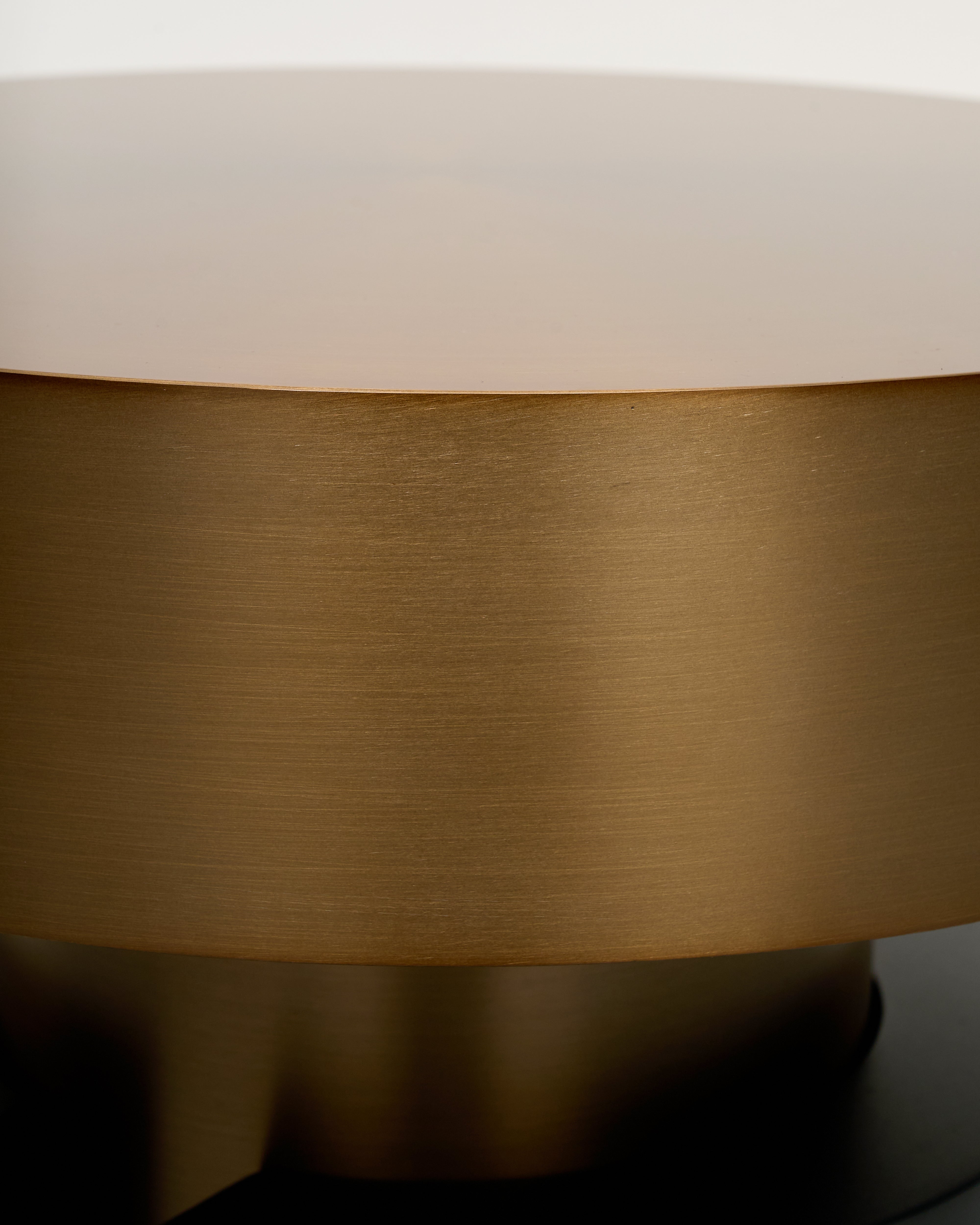 Close-up of a cylindrical object with a gold and beige finish.
