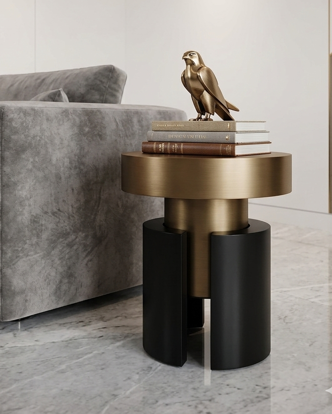 Modern living room with a gray sofa, gold and black side table, and a bird sculpture.