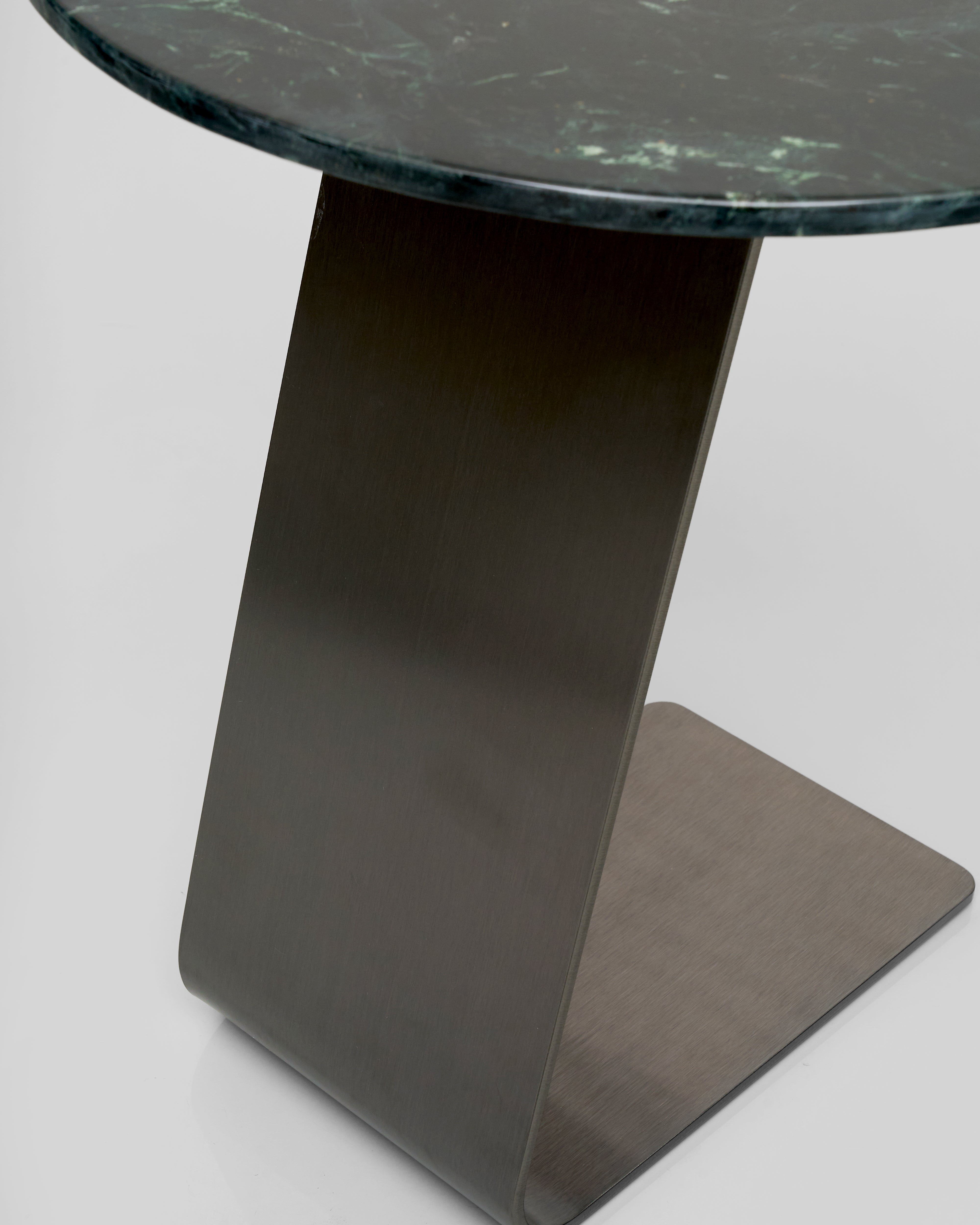 Side table with a dark marble top and base on a light gray background