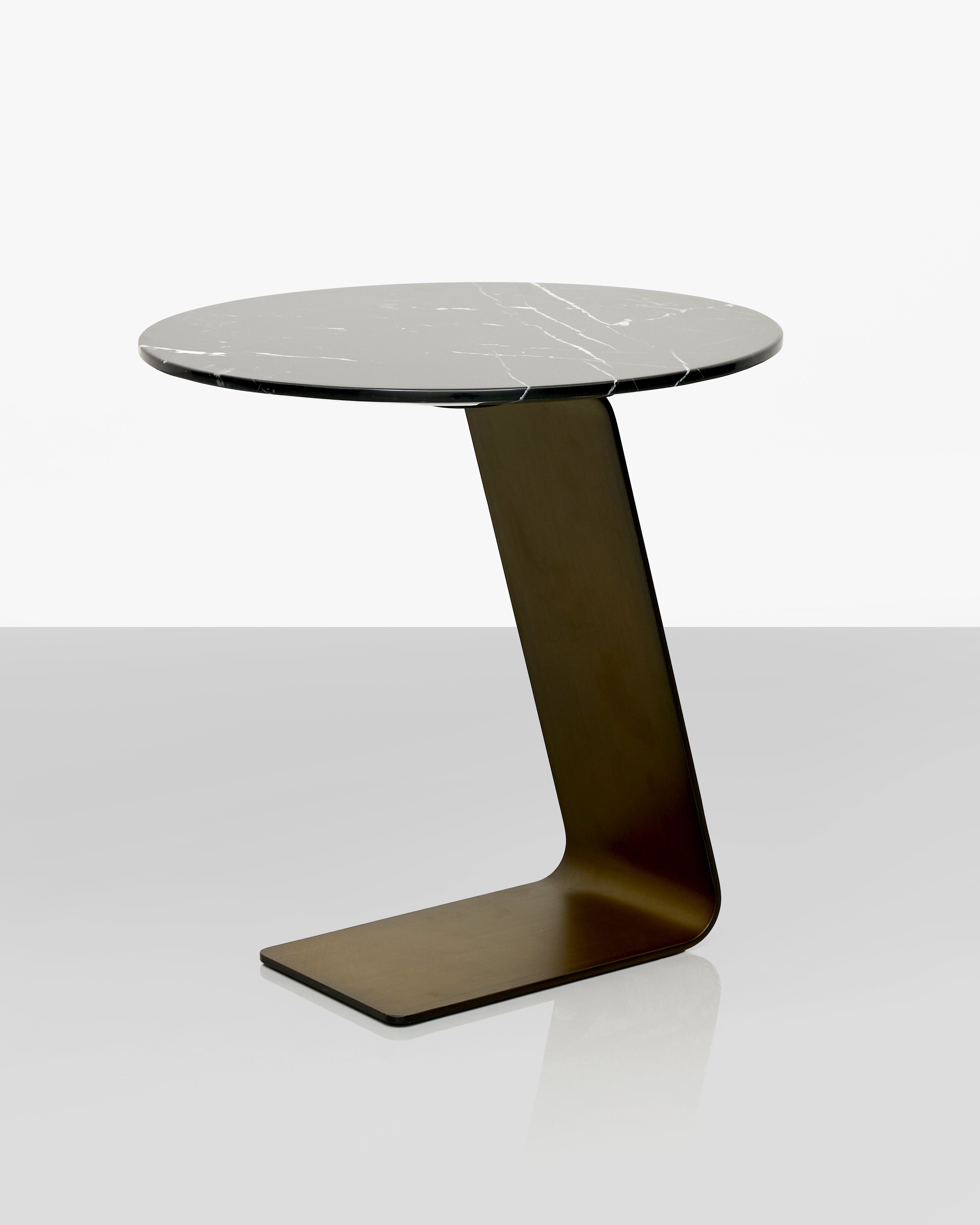 Modern side table with a marble top and unique base design on a white background