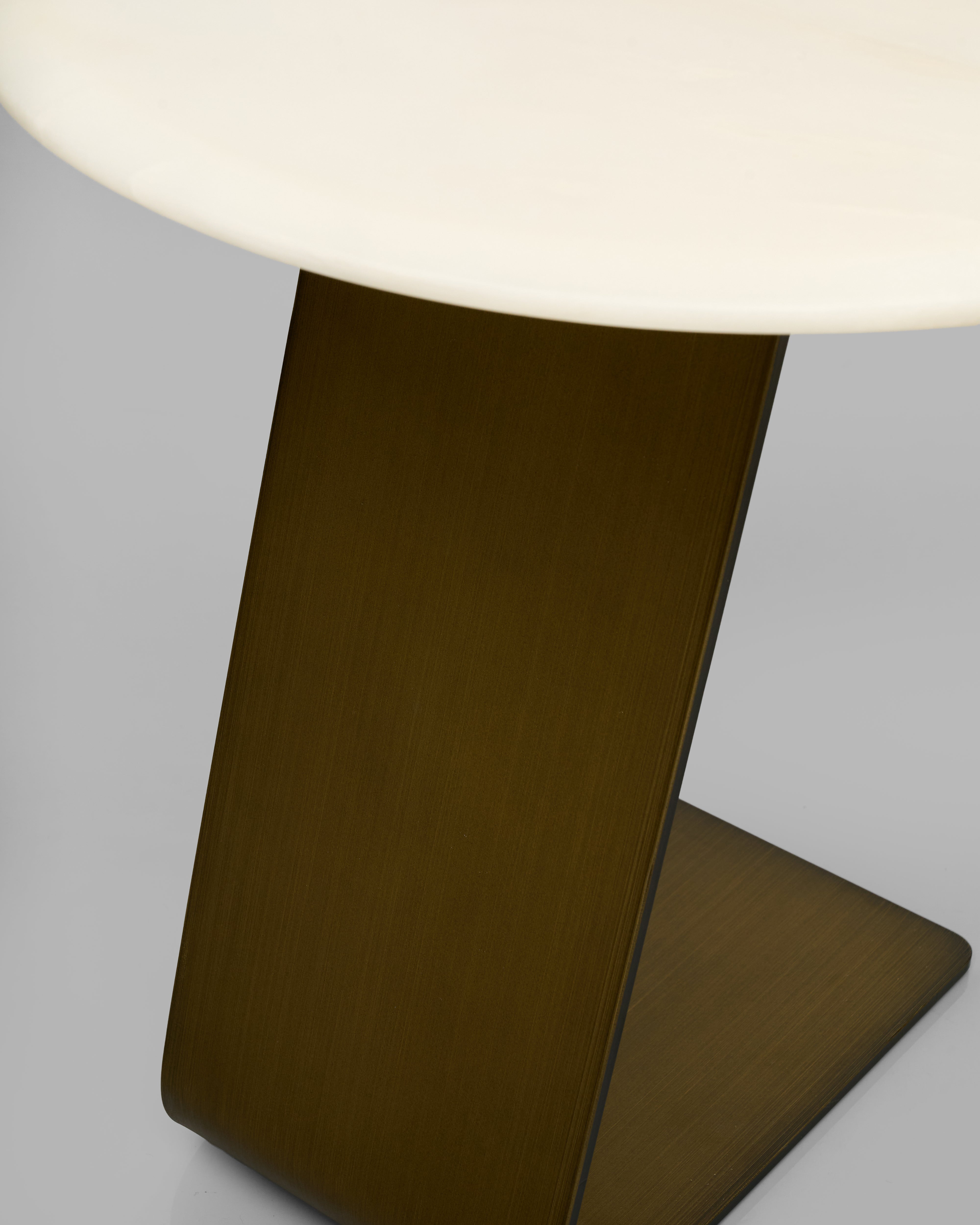 side table leg closeup with a brown base and white marble on top on a gray background