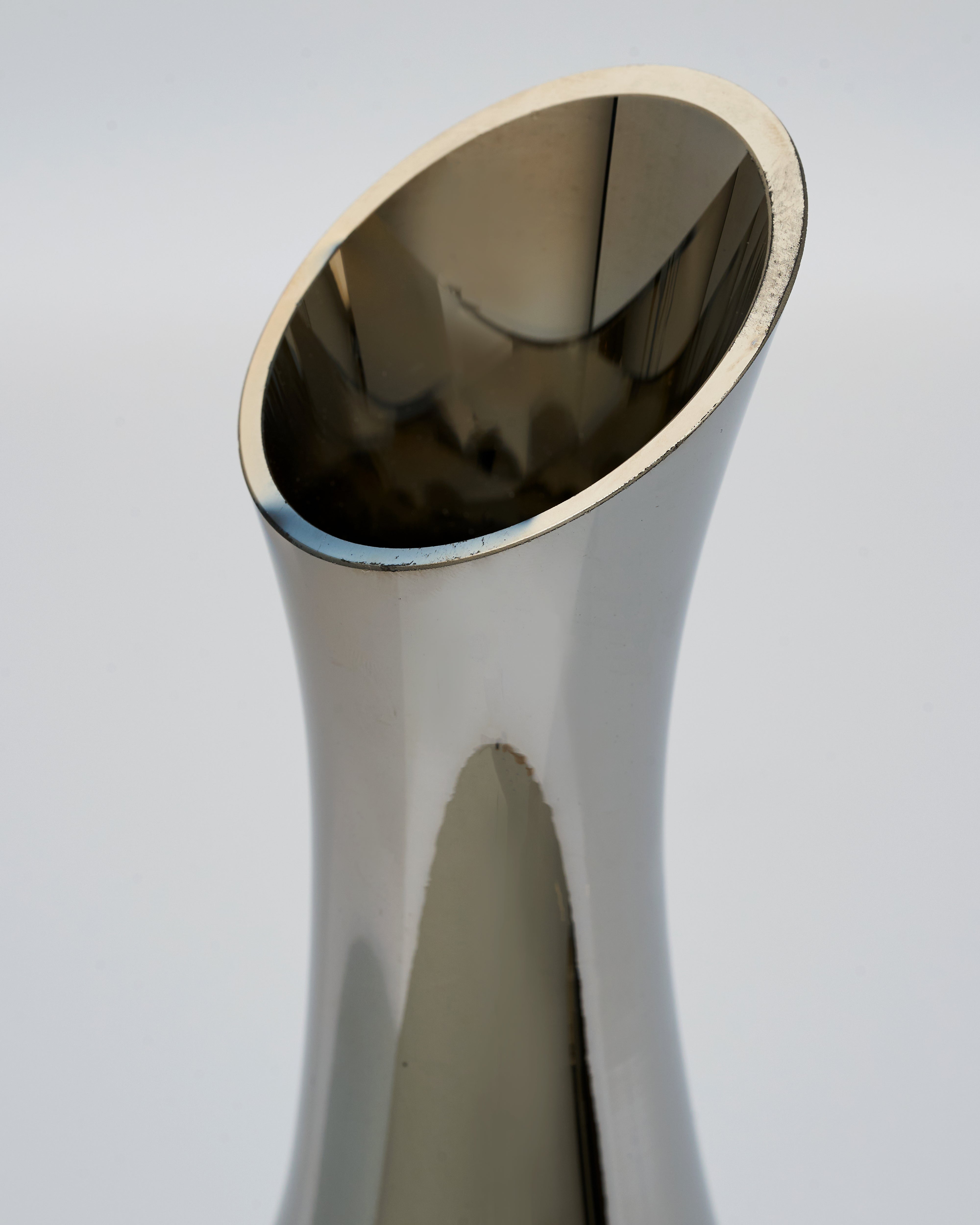 halo vase with a reflective surface on a light gray background