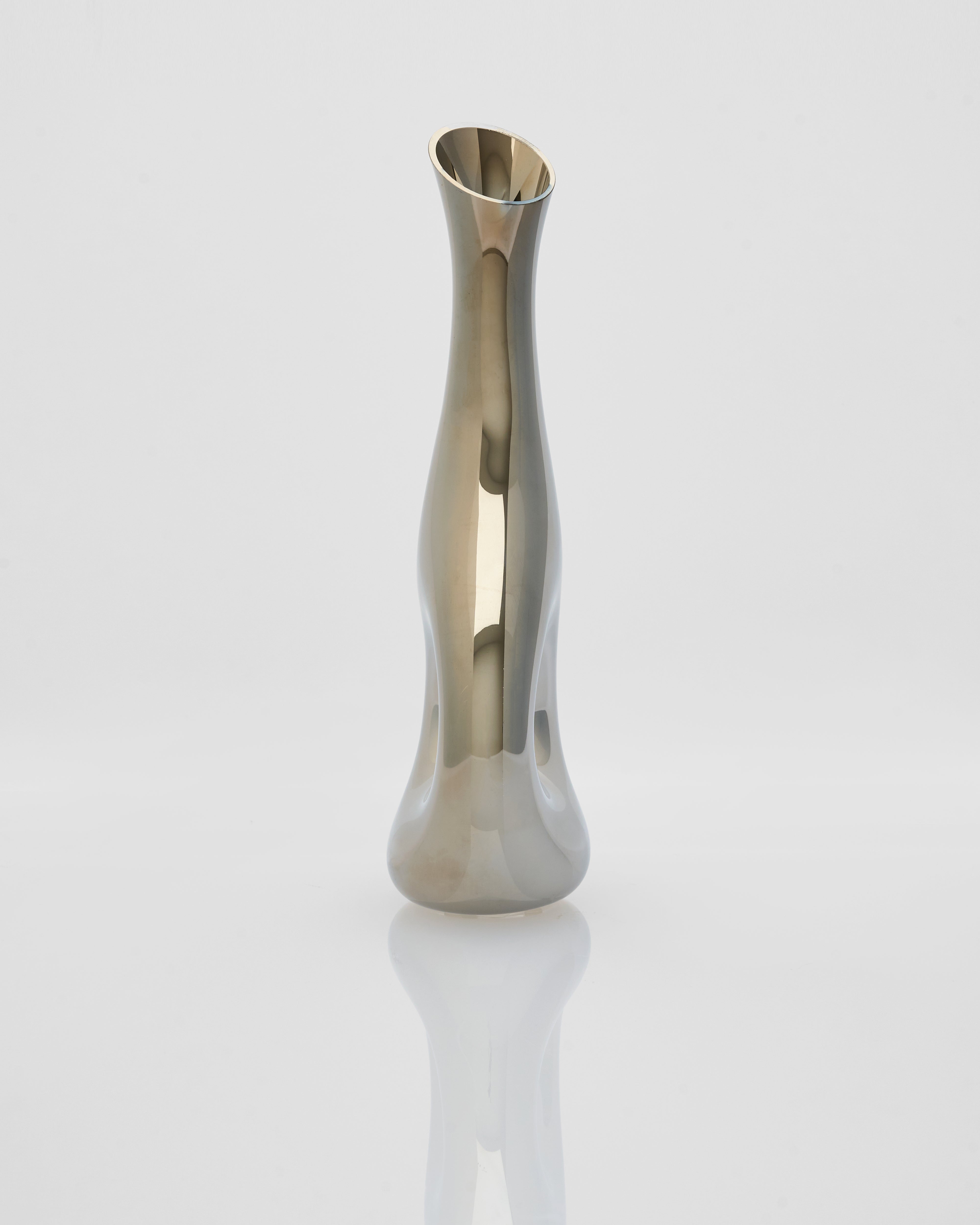 Silver vase with wavy design on a white background