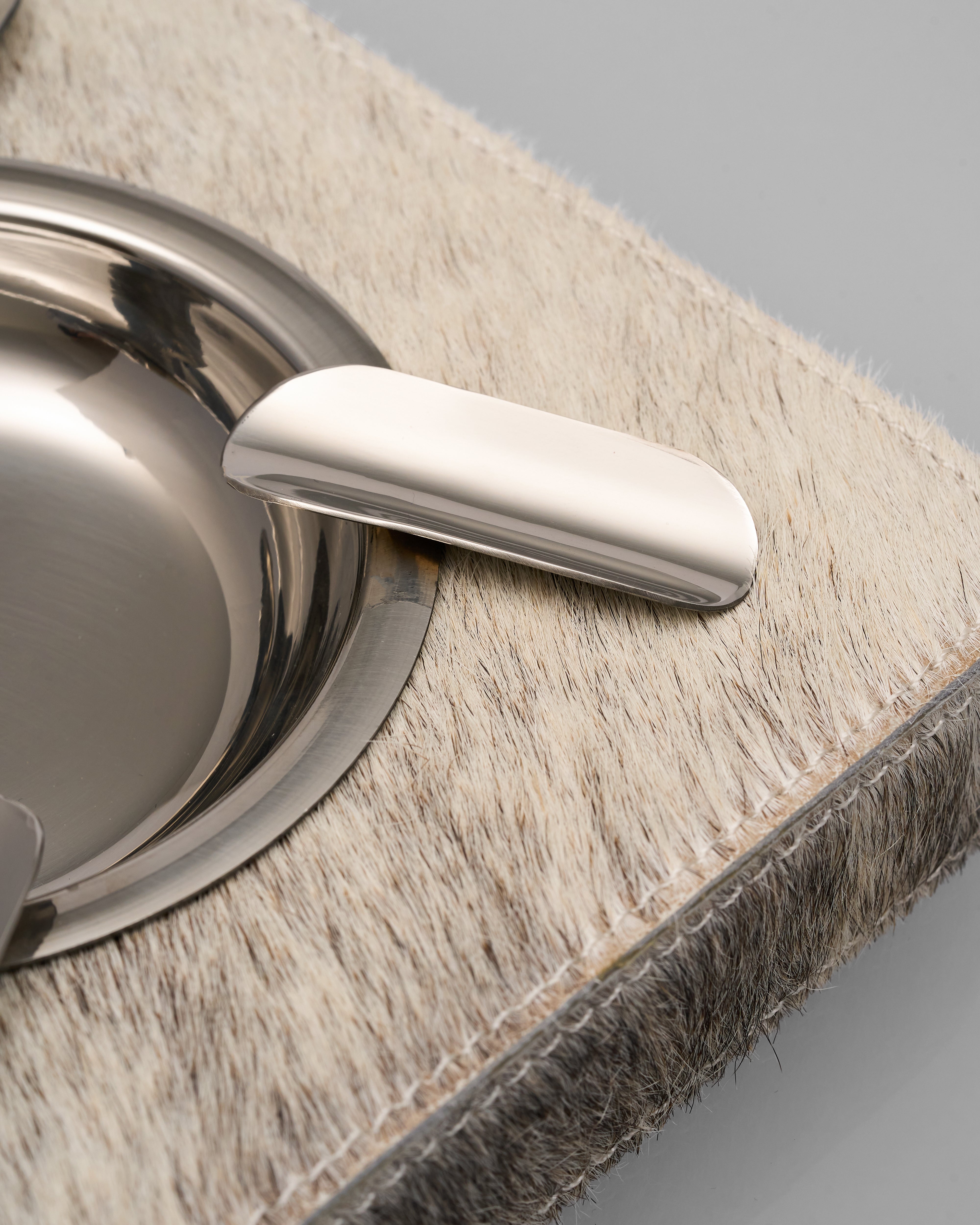 Metallic ashtray of natural horse hair like Avery Ashtray on a textured surface
