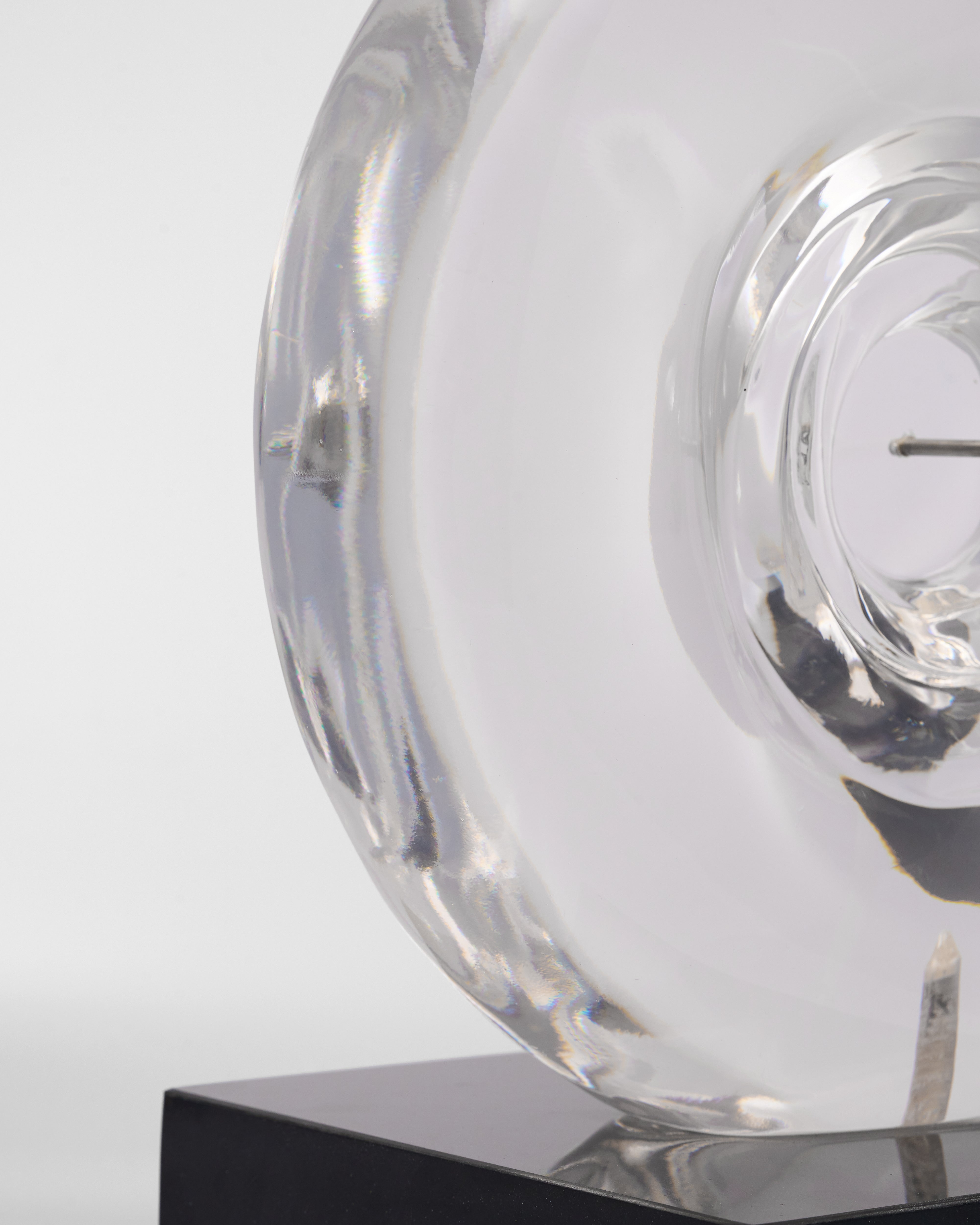 Clear glass vase with a spiral design on a white background