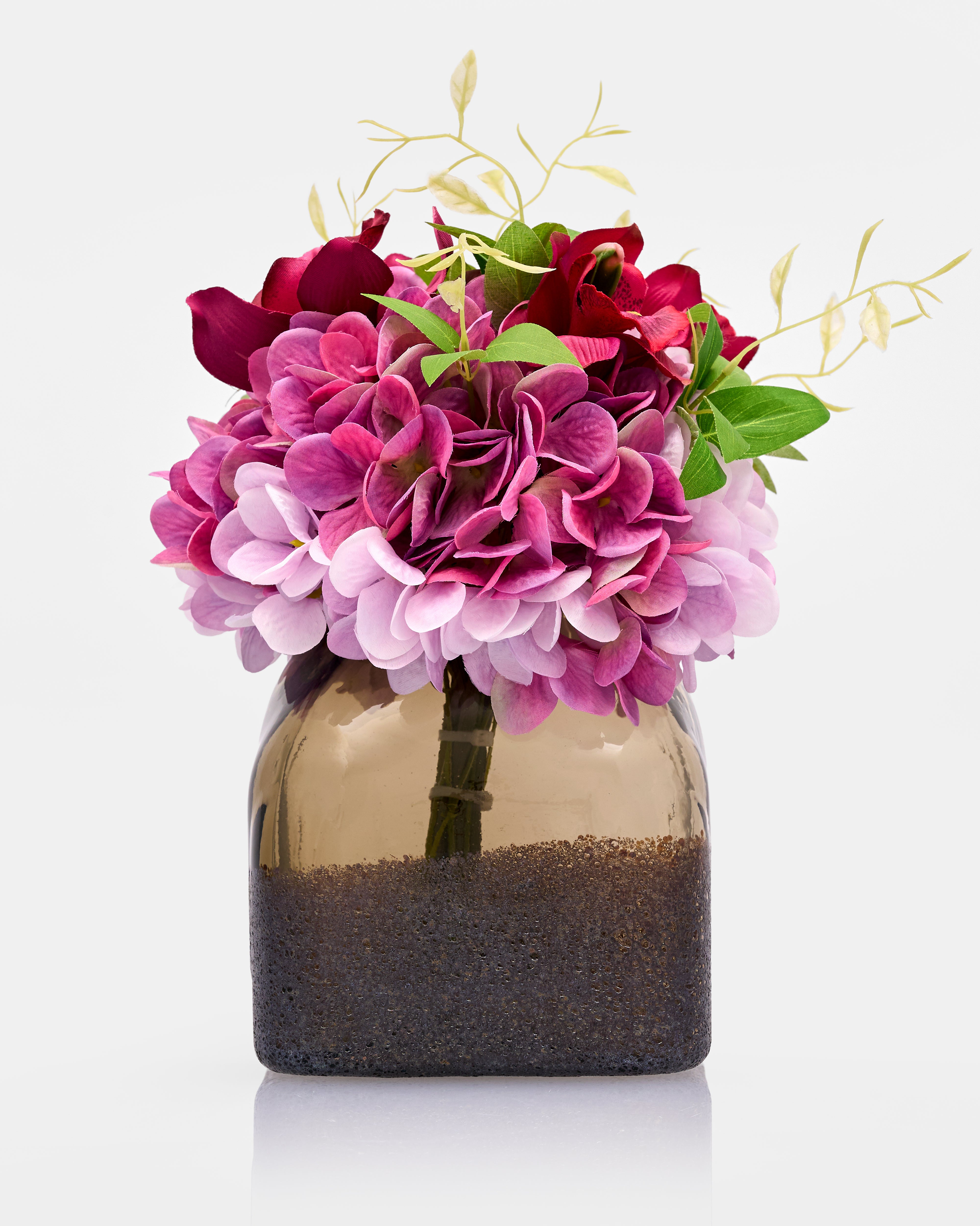 Decorative vase with pink and red flowers on a white background