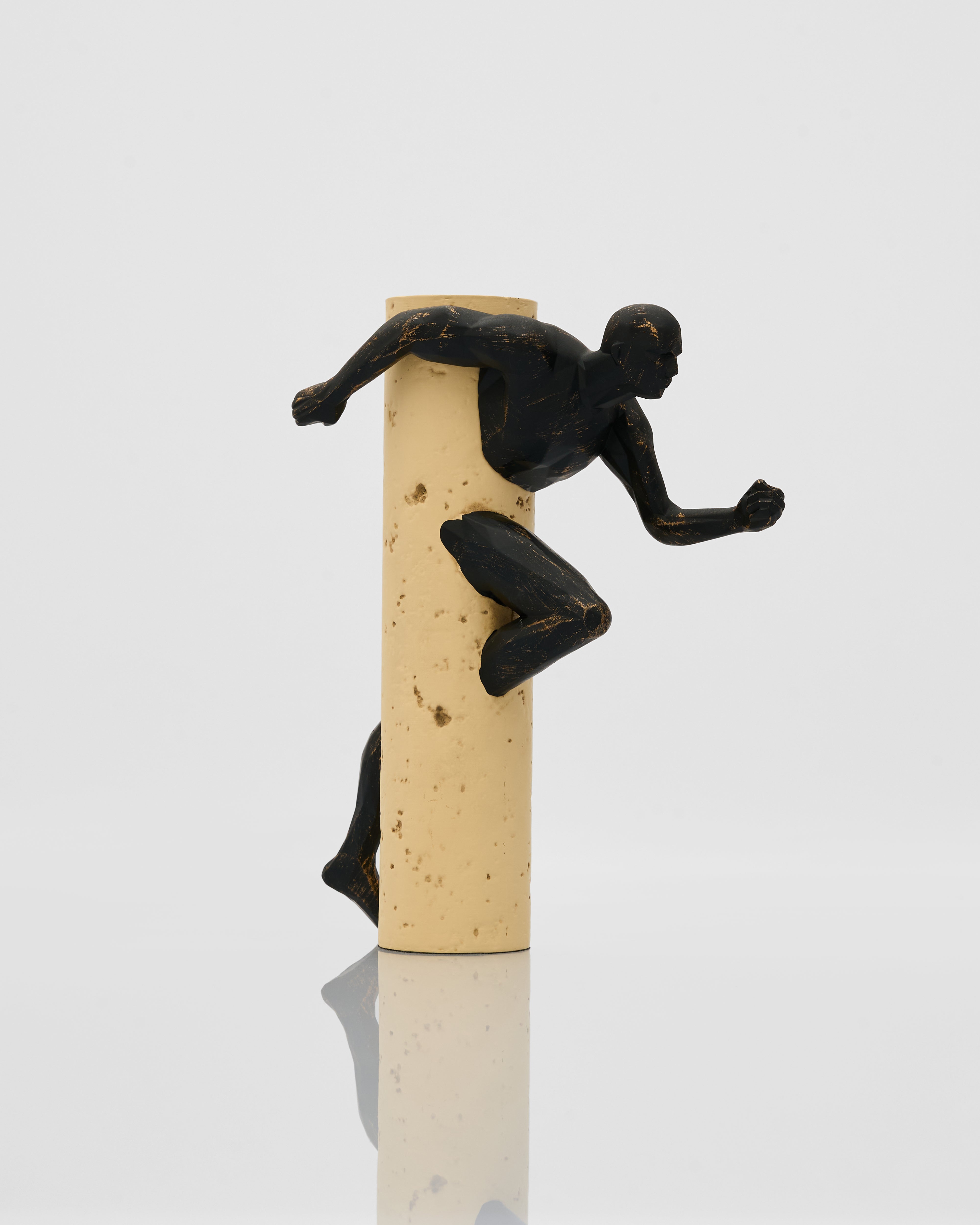 Decorative candle with black figurines on a white background