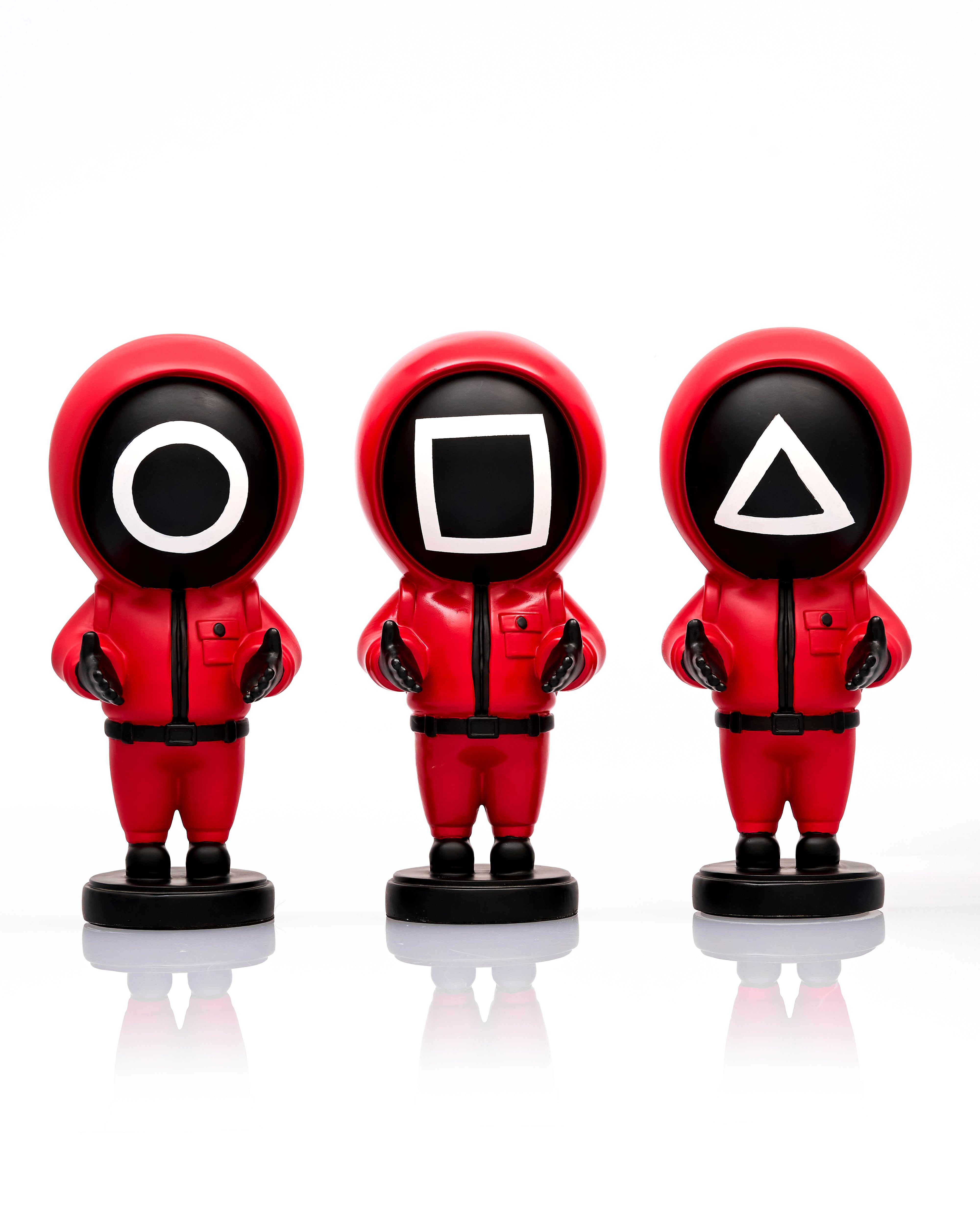 Three red astronaut figurines with different symbol masks on a white background