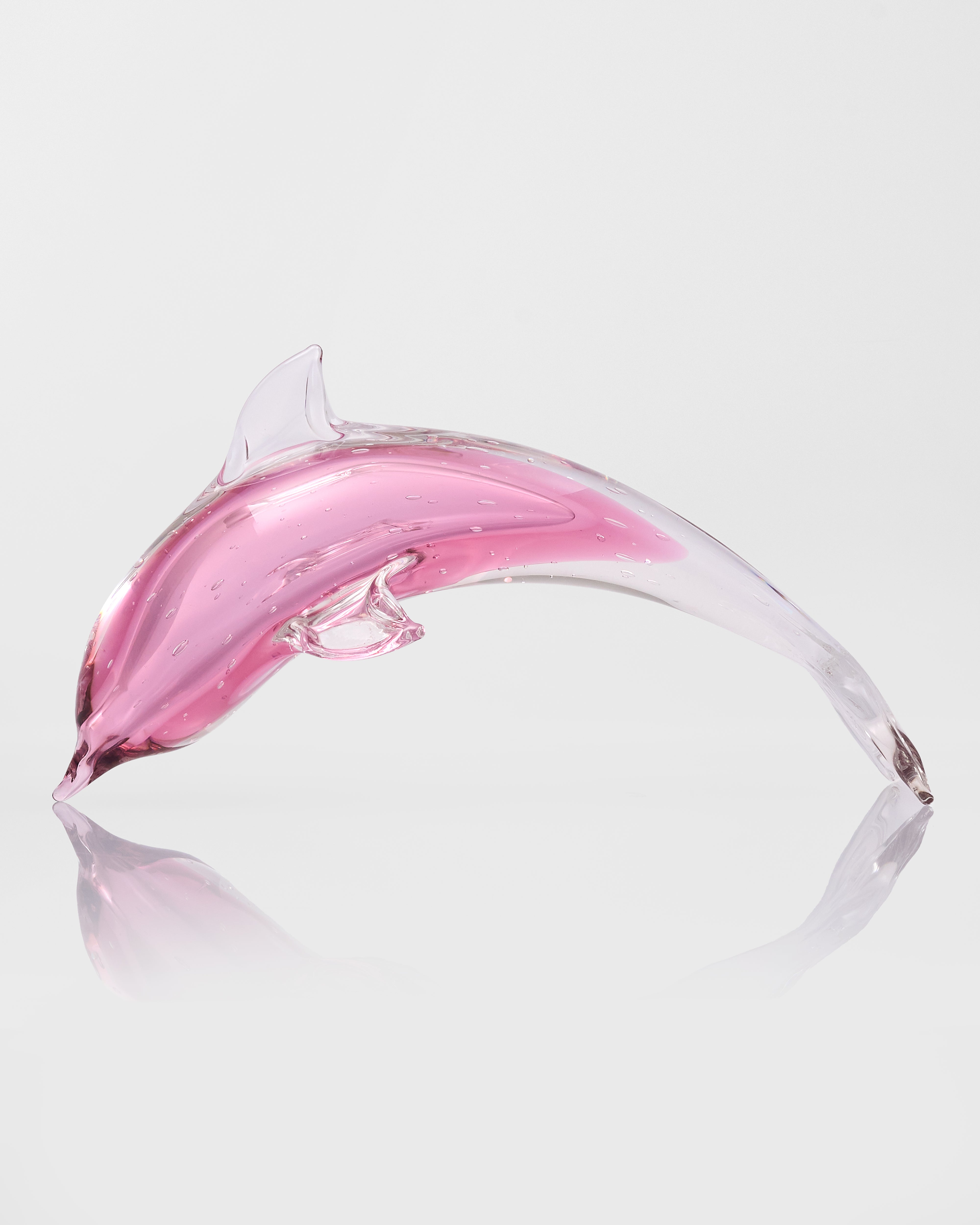 Pink dolphin-shaped bottle on a white background