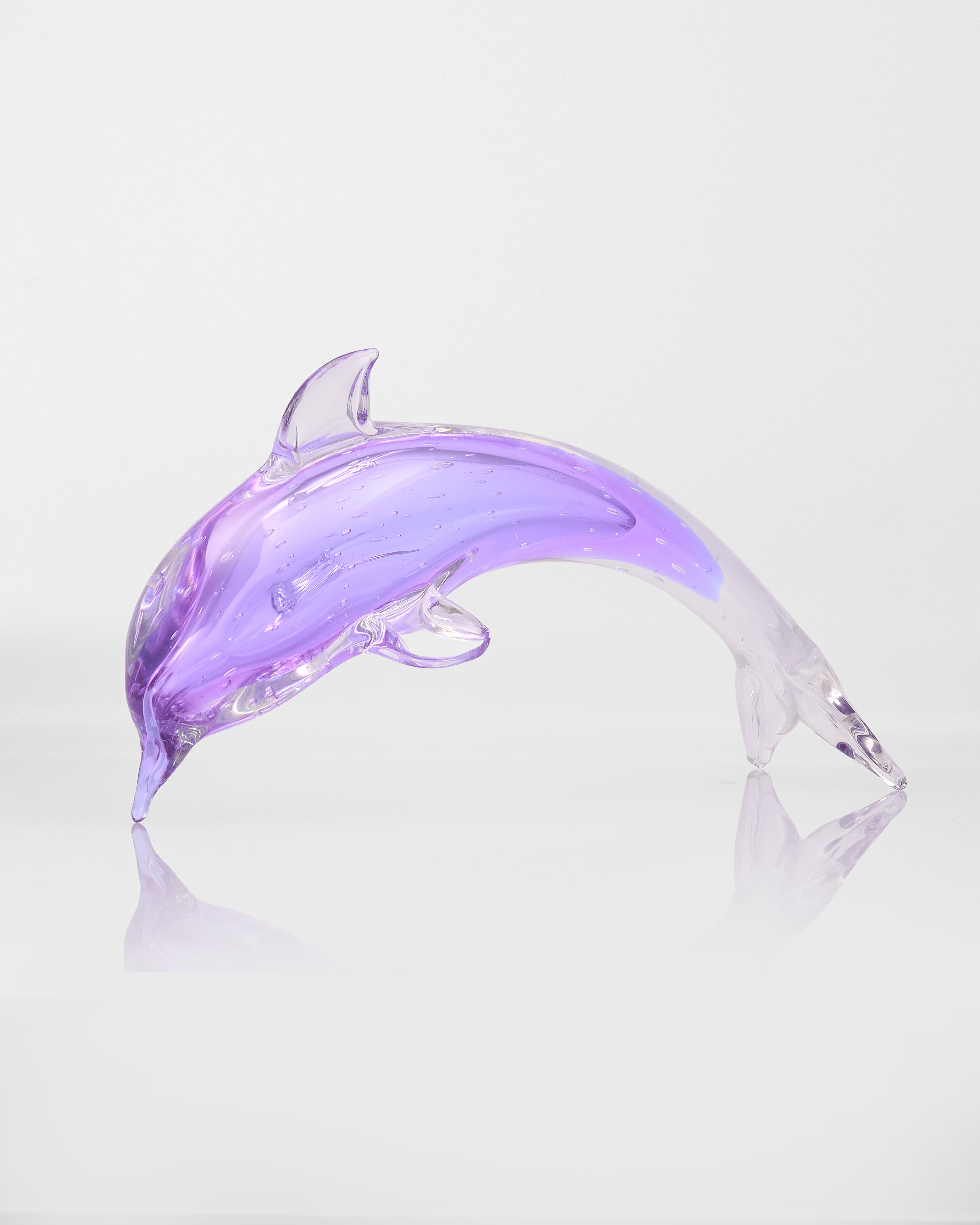 Purple dolphin-shaped object on a white background