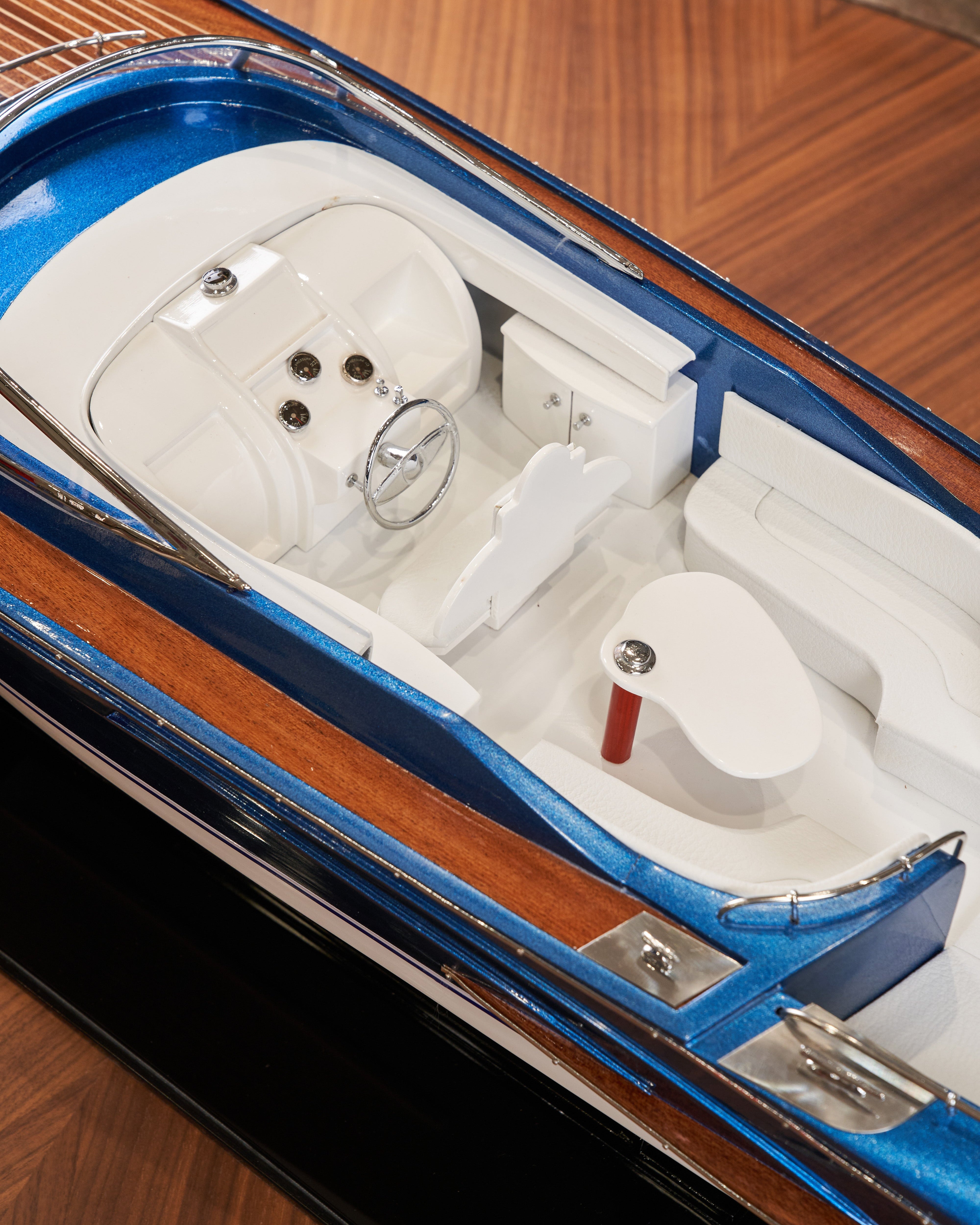 Model boat on a wooden surface with a blurred background