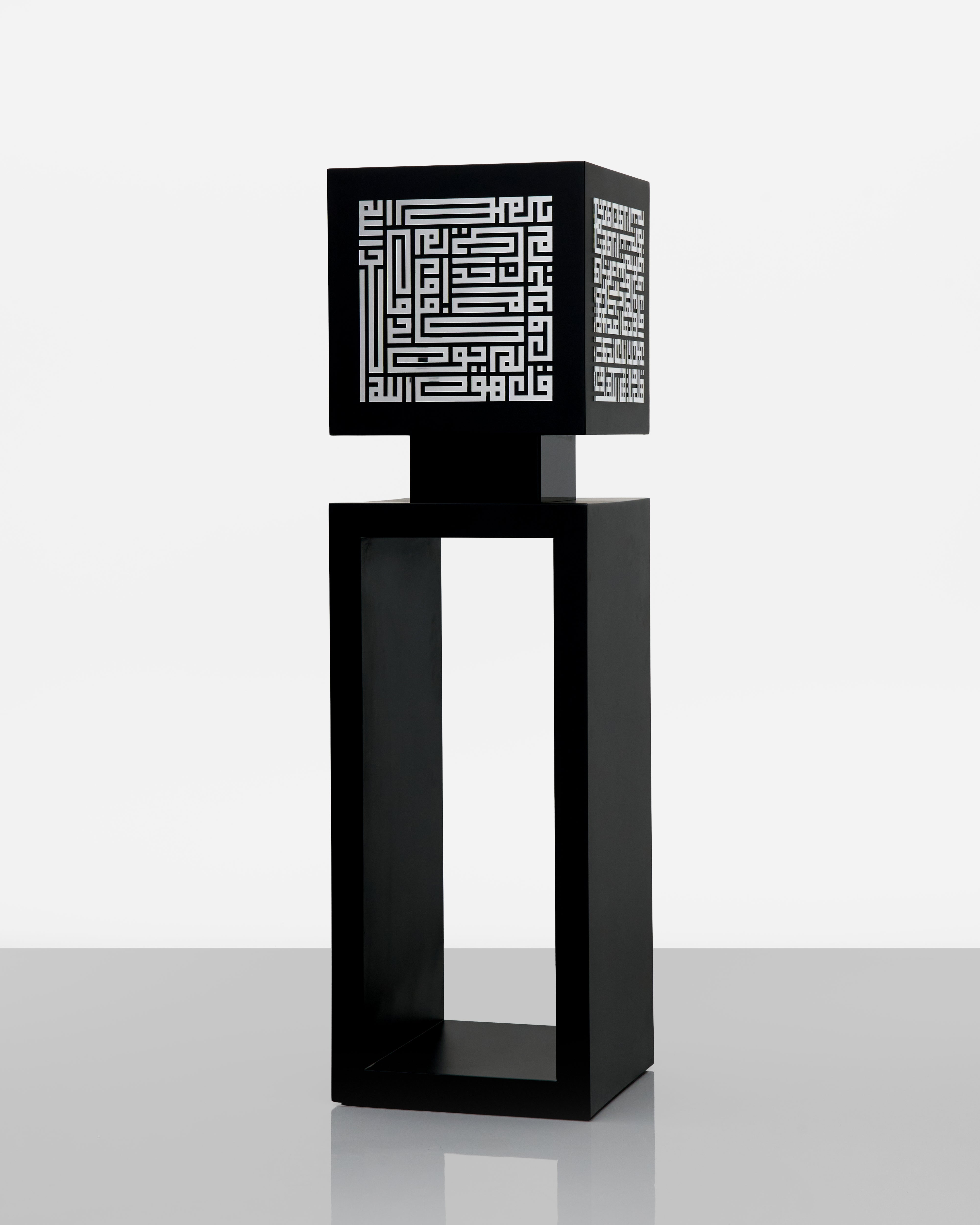 Black decorative lamp with geometric pattern on a white background