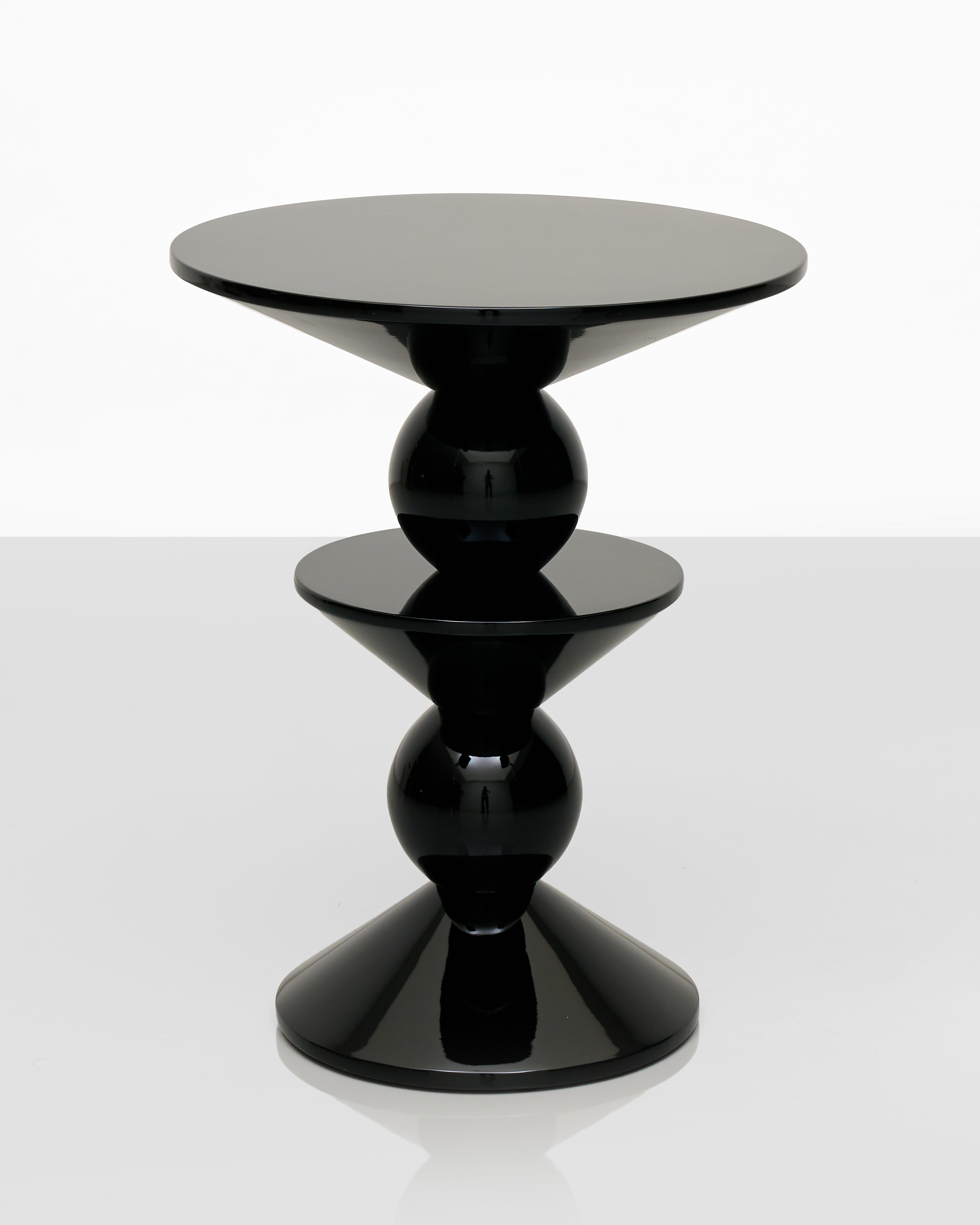 Modern black side table with a white background