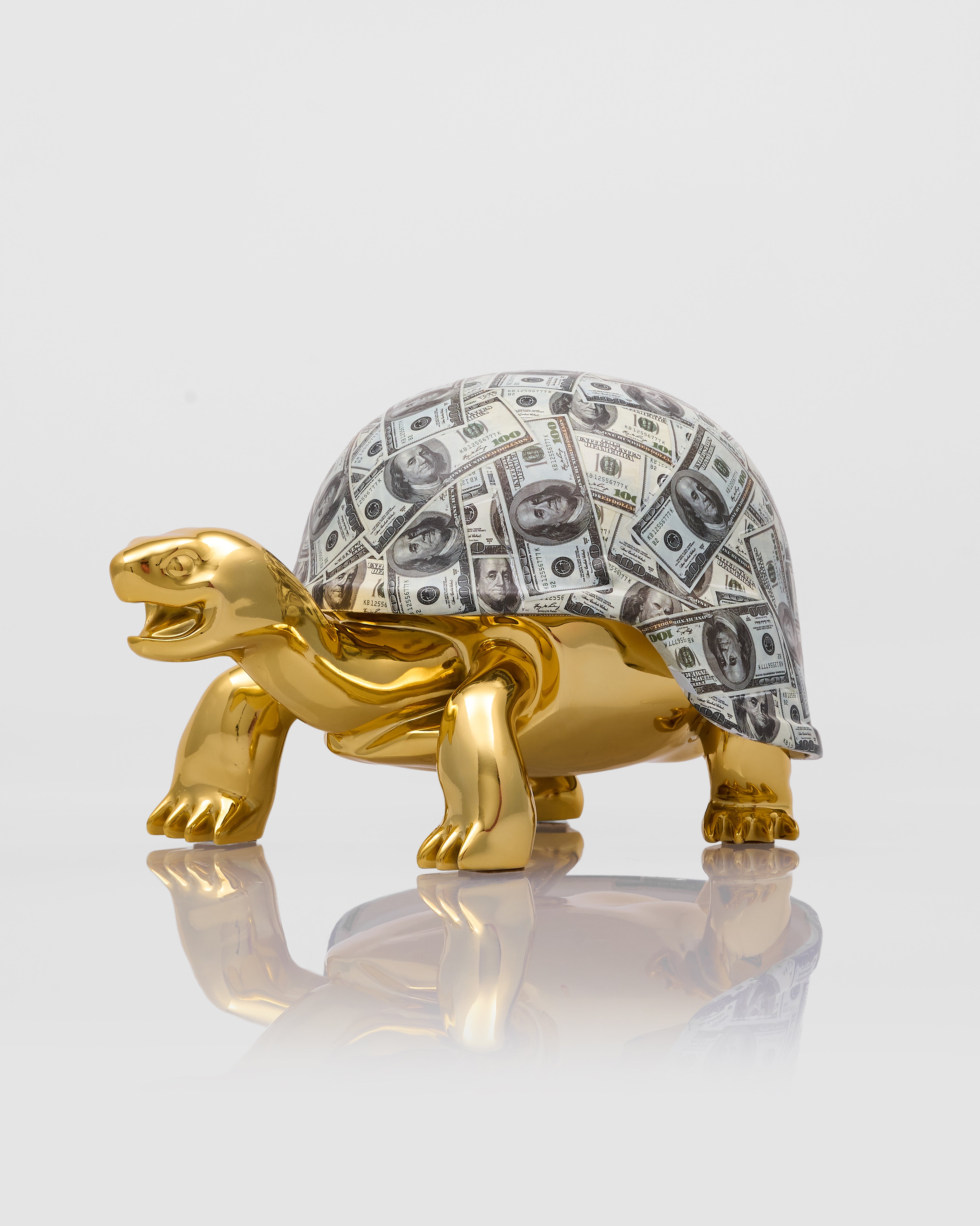 Gold turtle figurine with a shell made of dollar bills