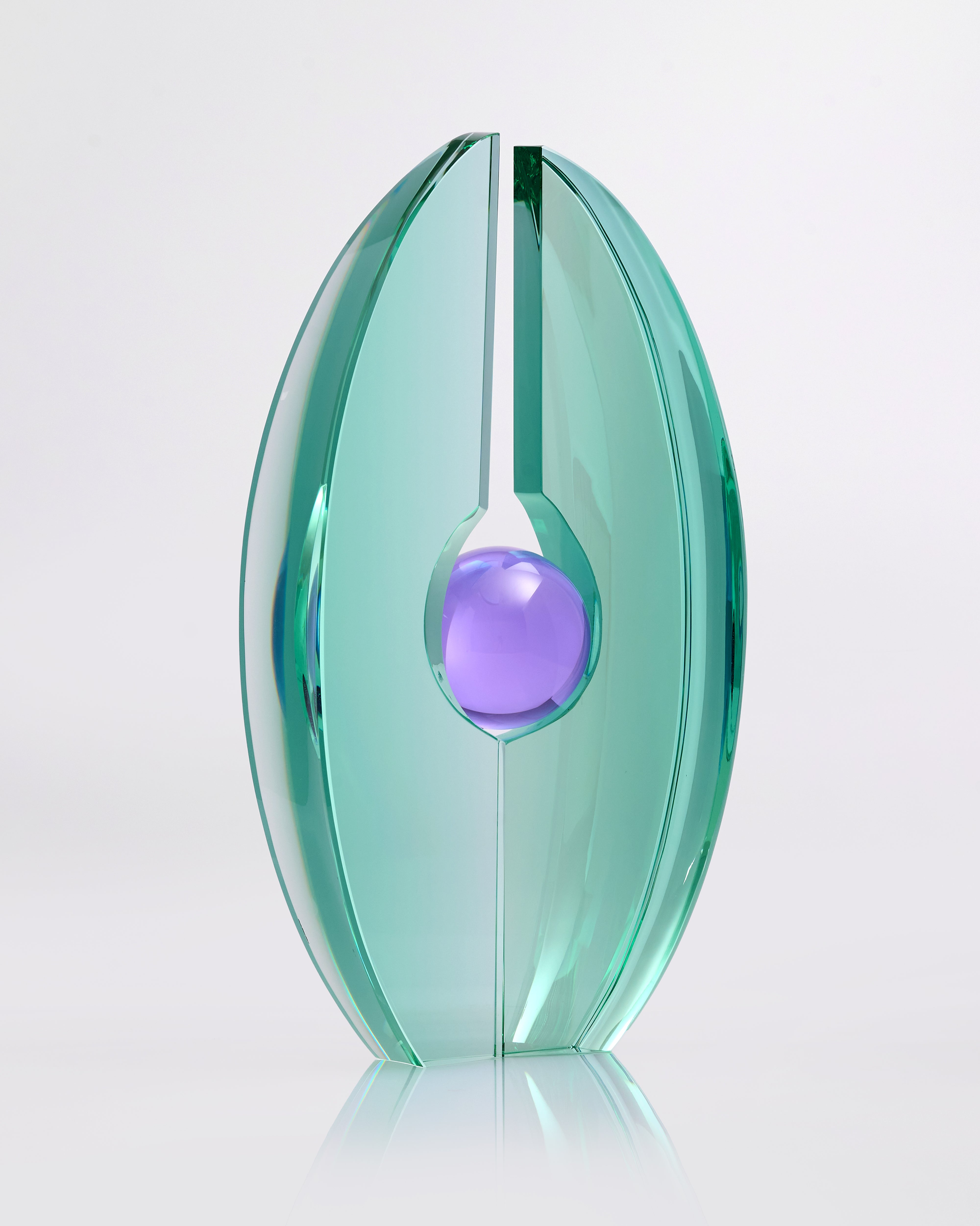 Teal and purple glass sculpture on a white background