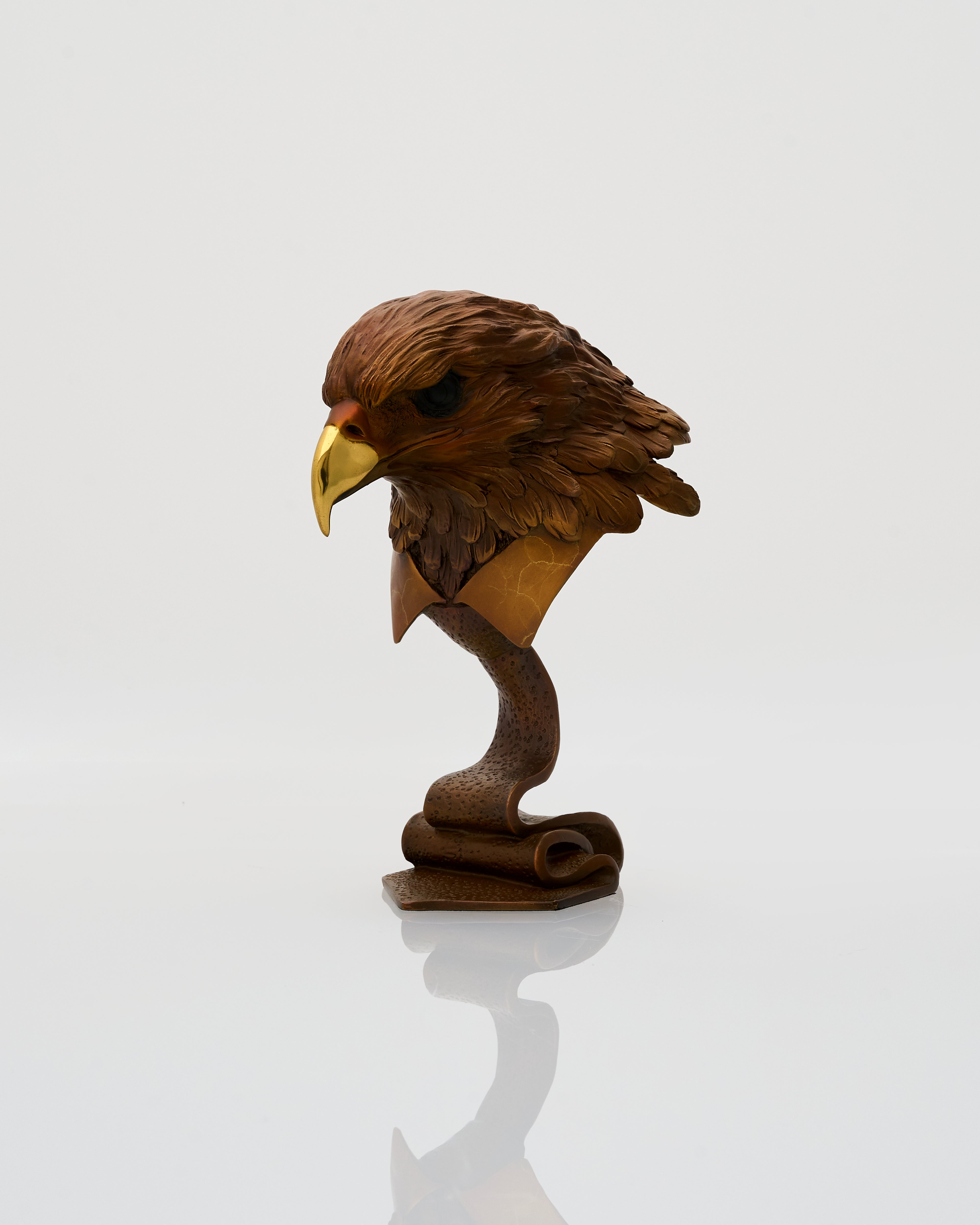 Wooden eagle head sculpture on a white background
