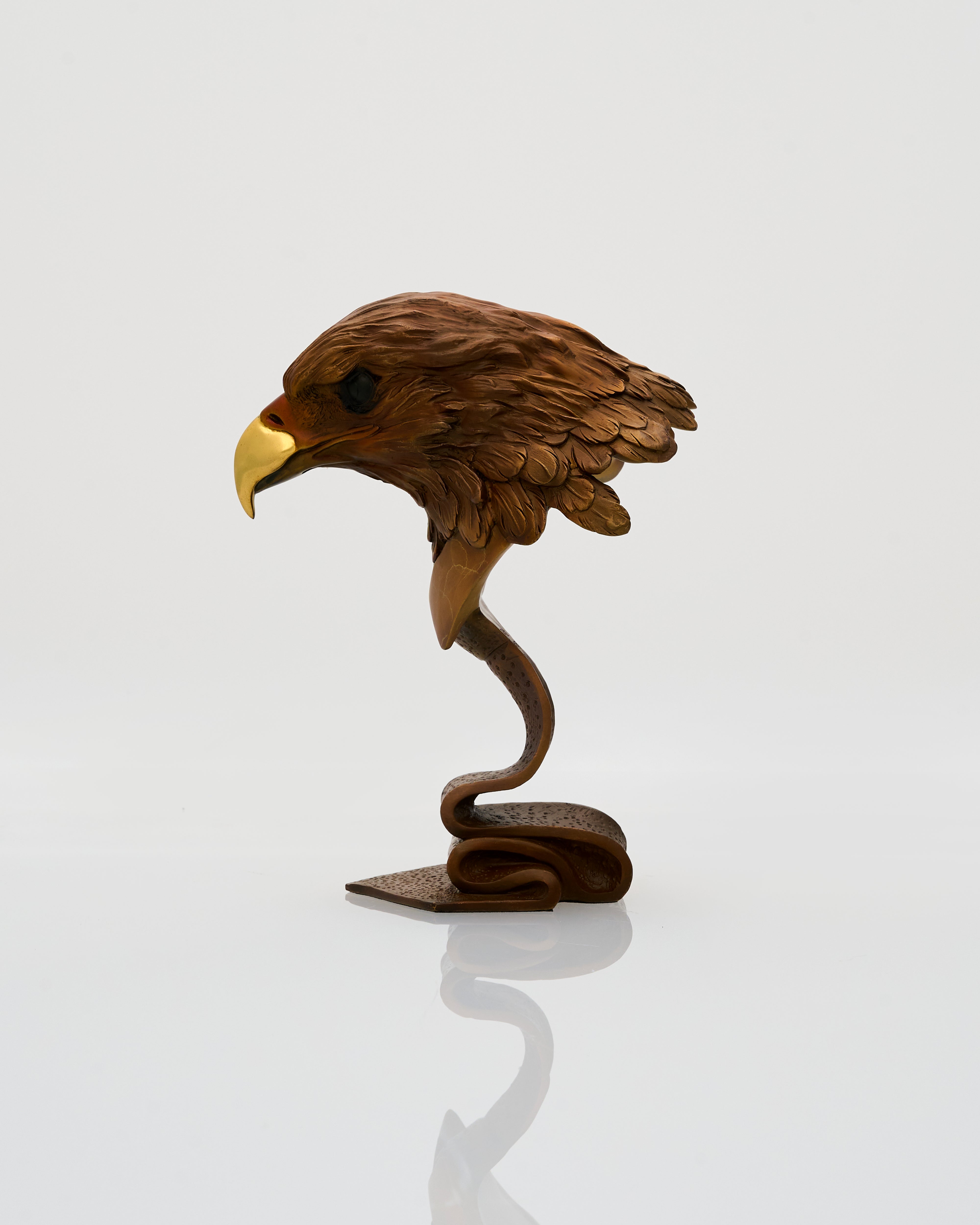 Wooden sculpture of an eagle head on a white background