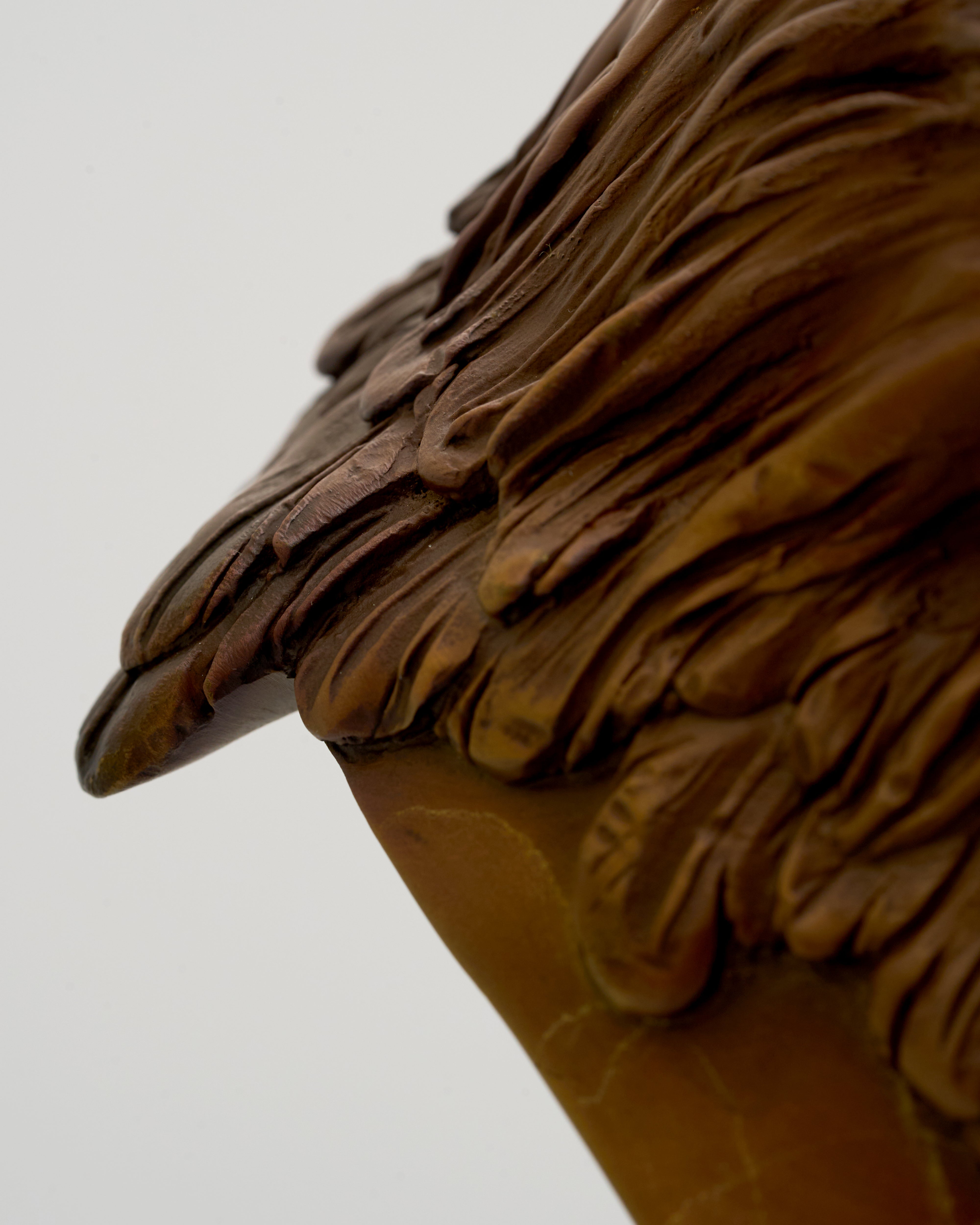 Close-up of a eagle's head sculpture on a plain background