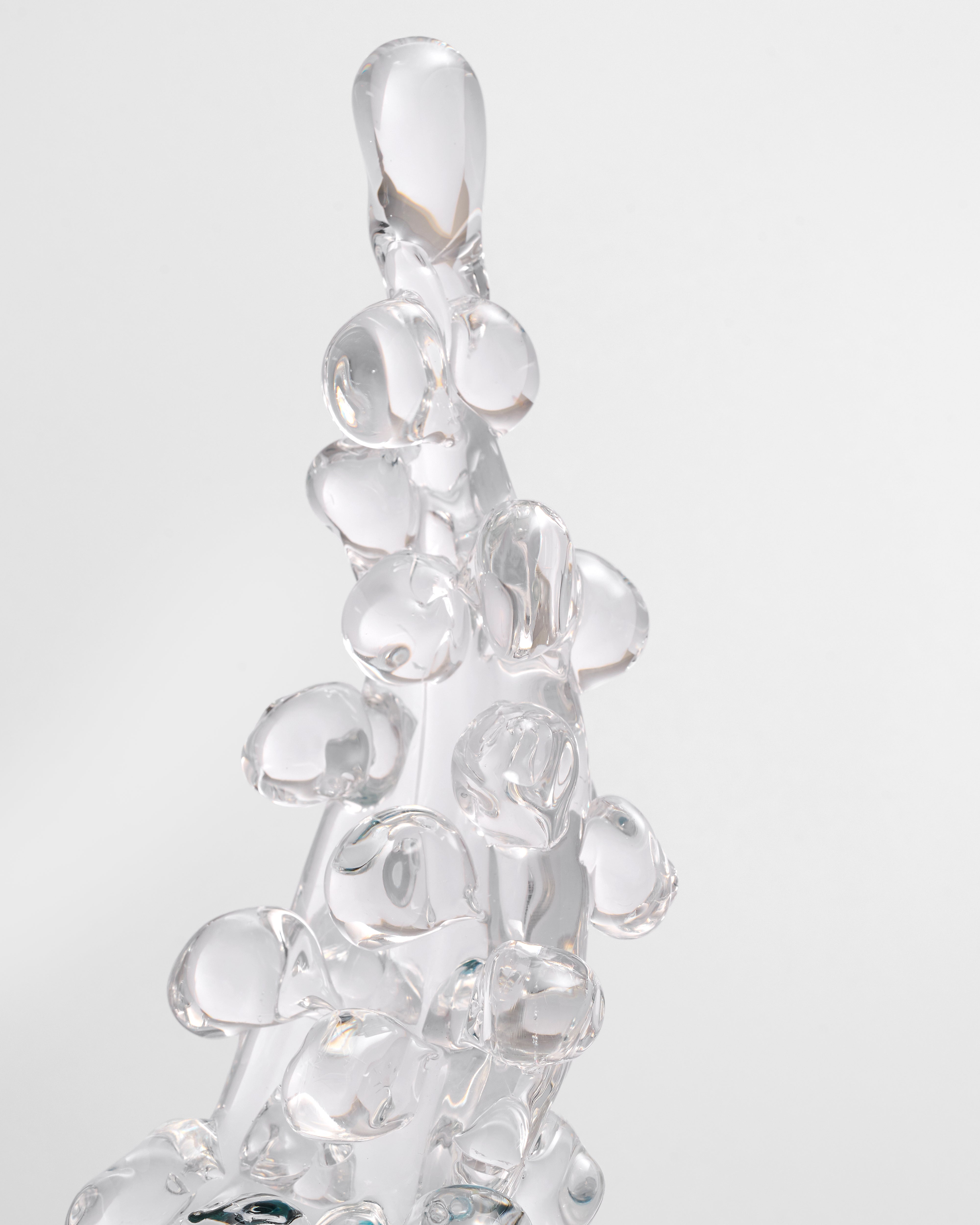 Clear glass pendant with bubble design on a light gray background