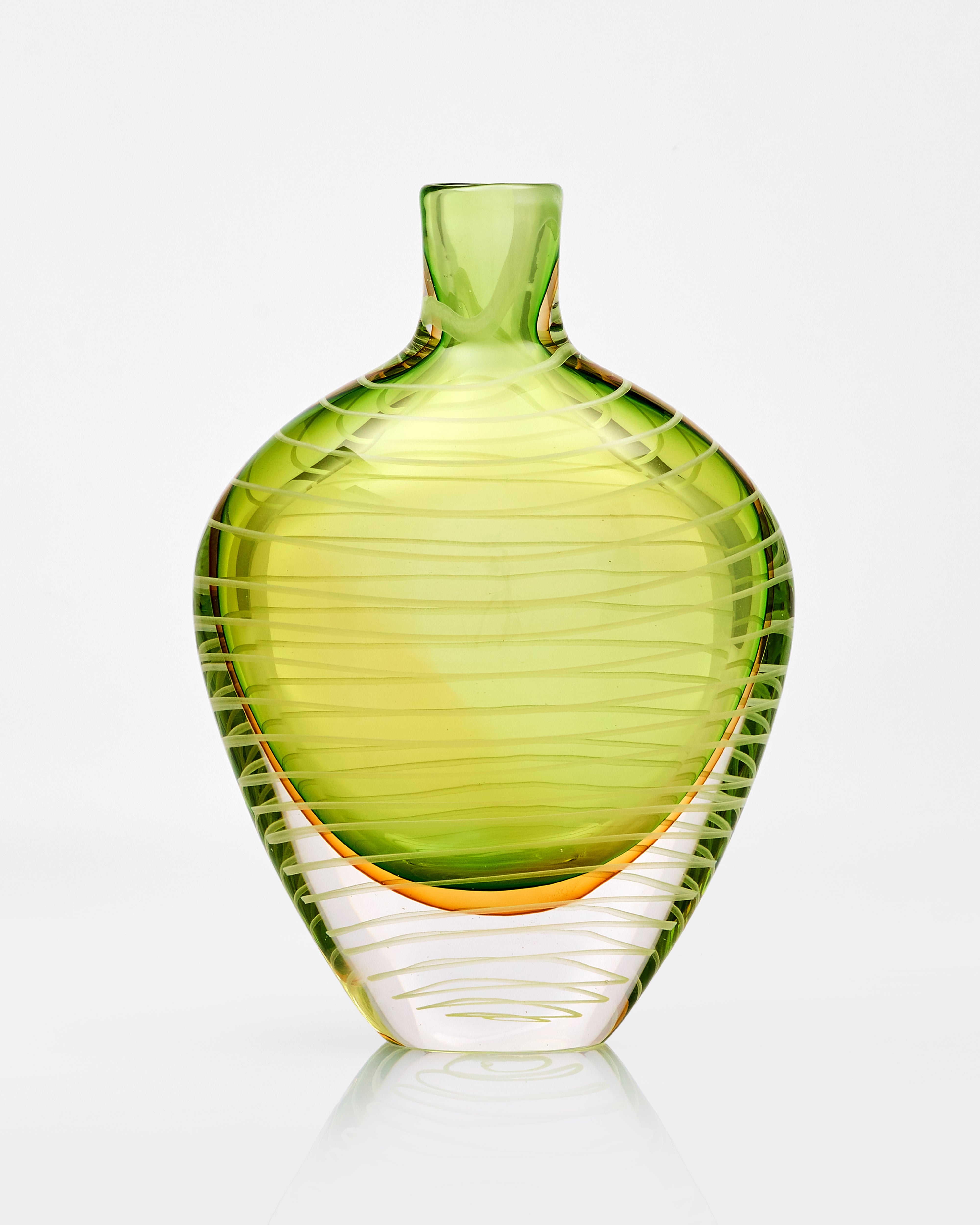Green glass vase with ribbed texture on a white background