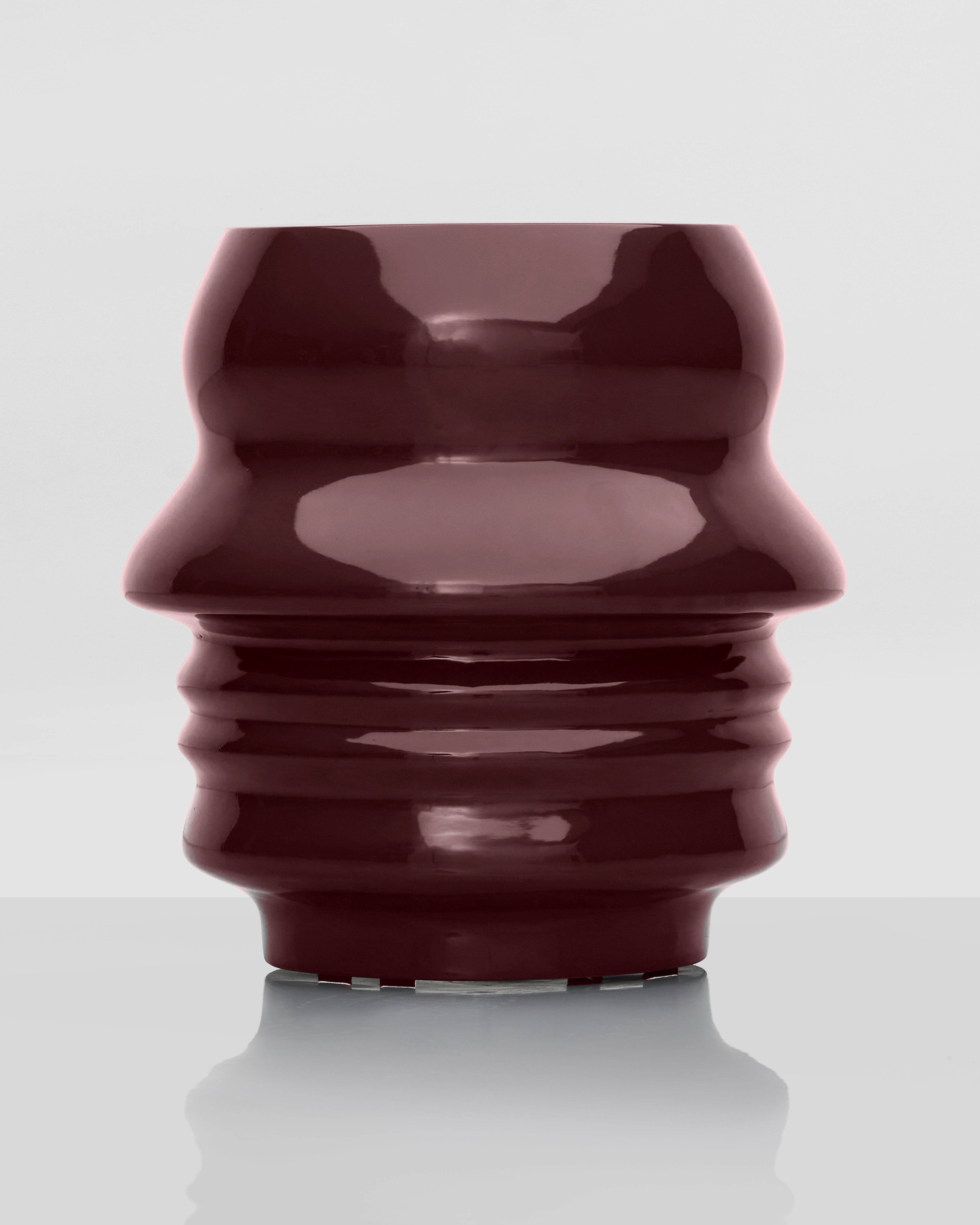Glossy red-brown ceramic vase on a white background