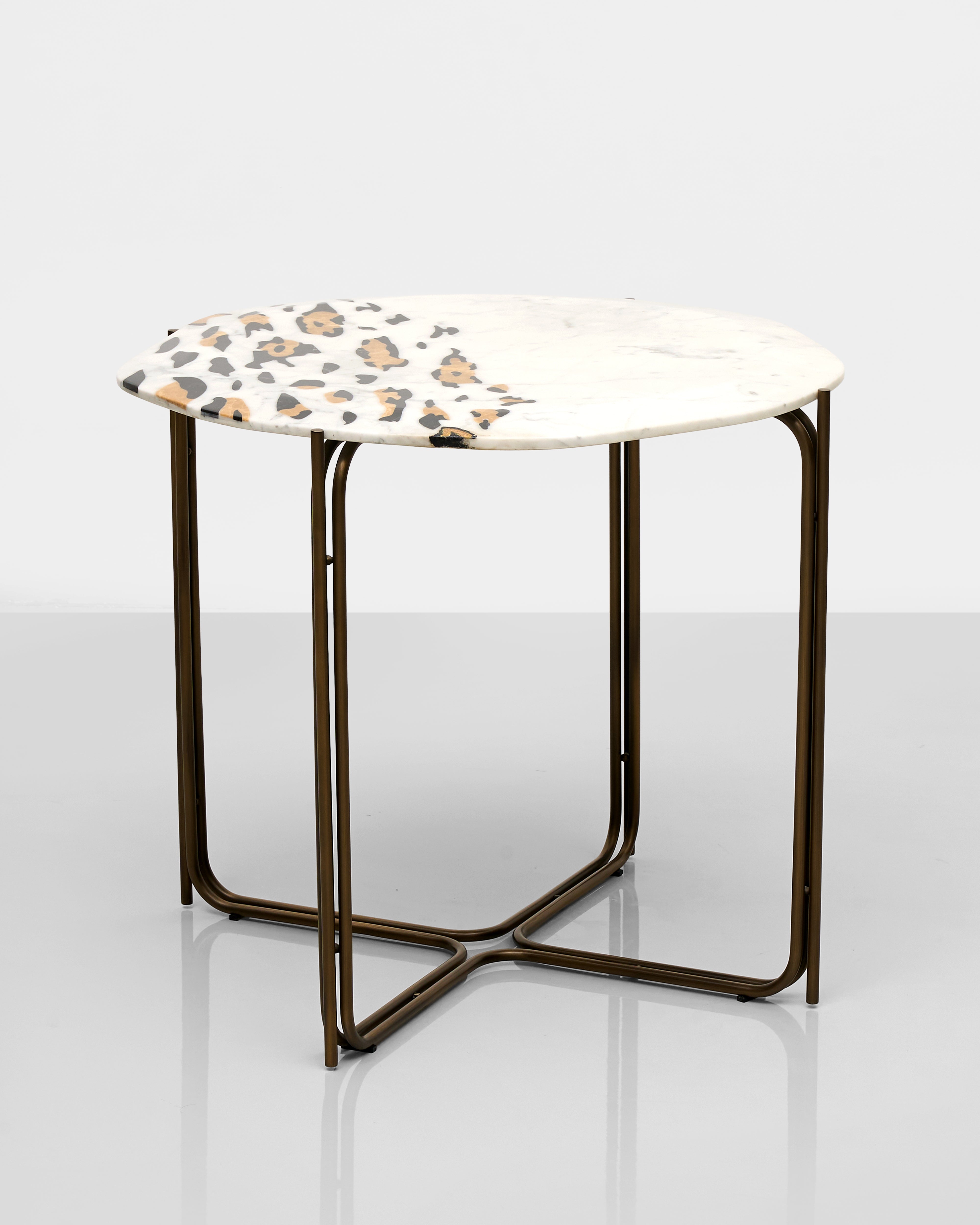 Small round table with a patterned top on a white background