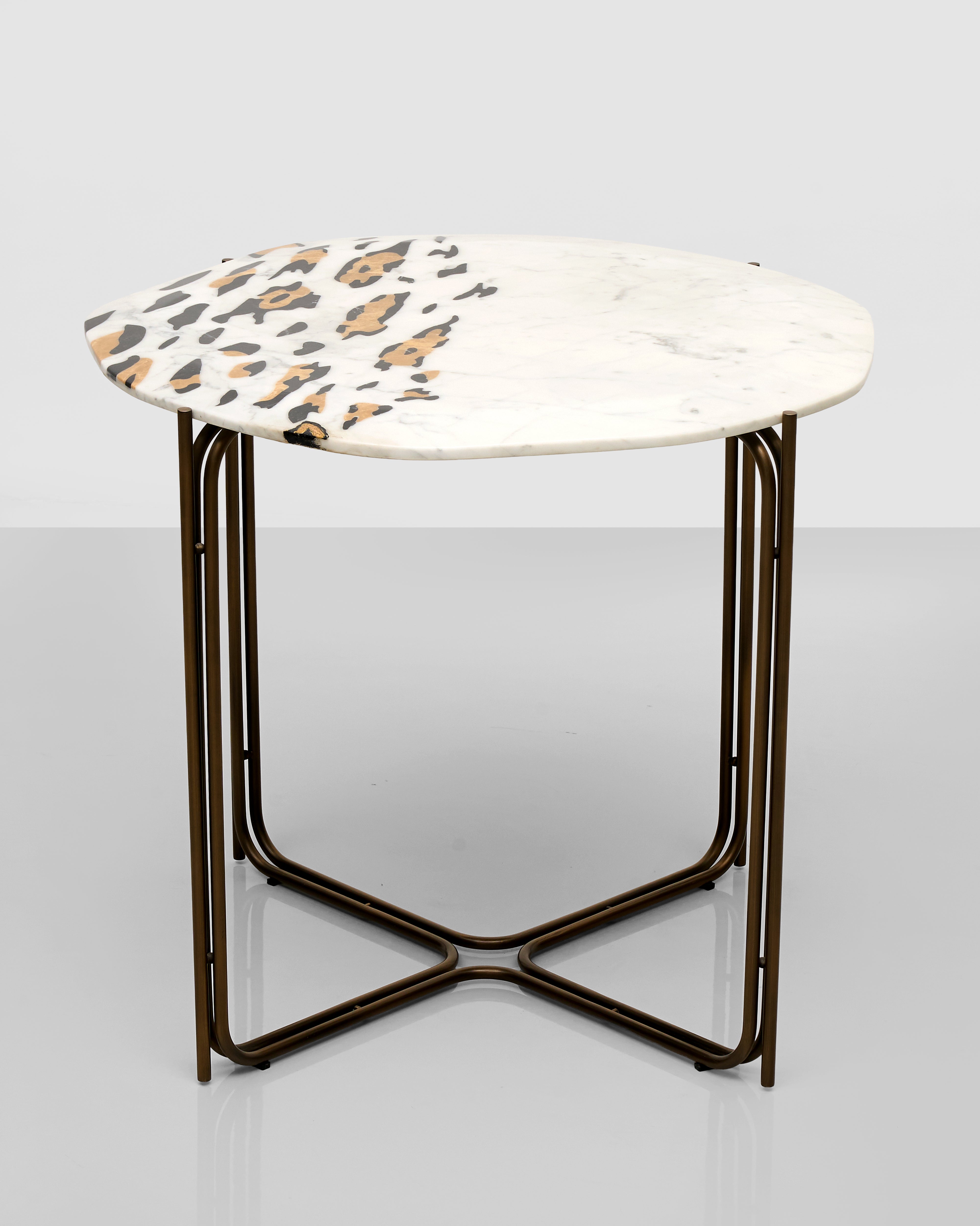 Round side table with marble-like top and bronze metal frame on a light gray background