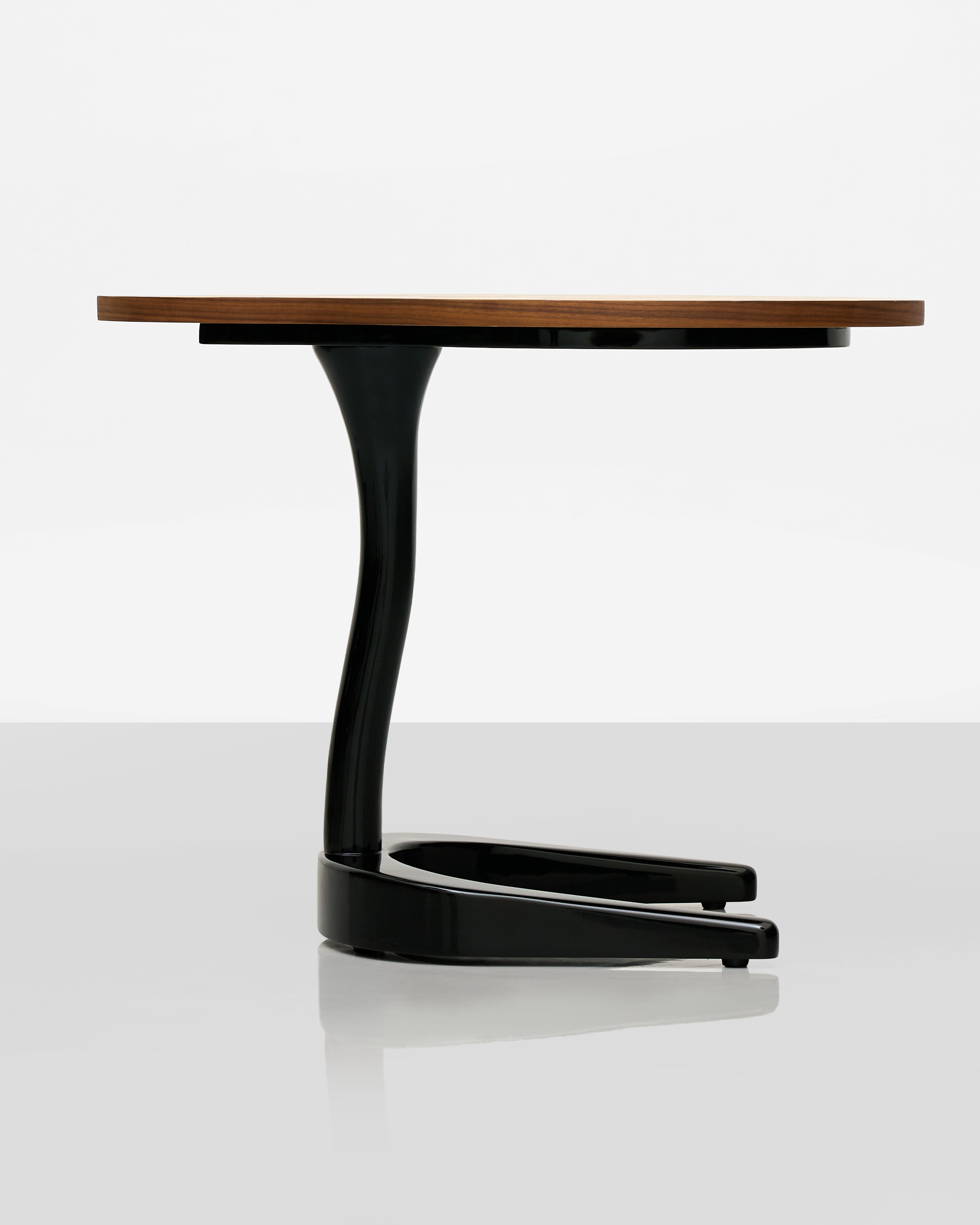 Modern table with a wooden top and black curved legs on a white background