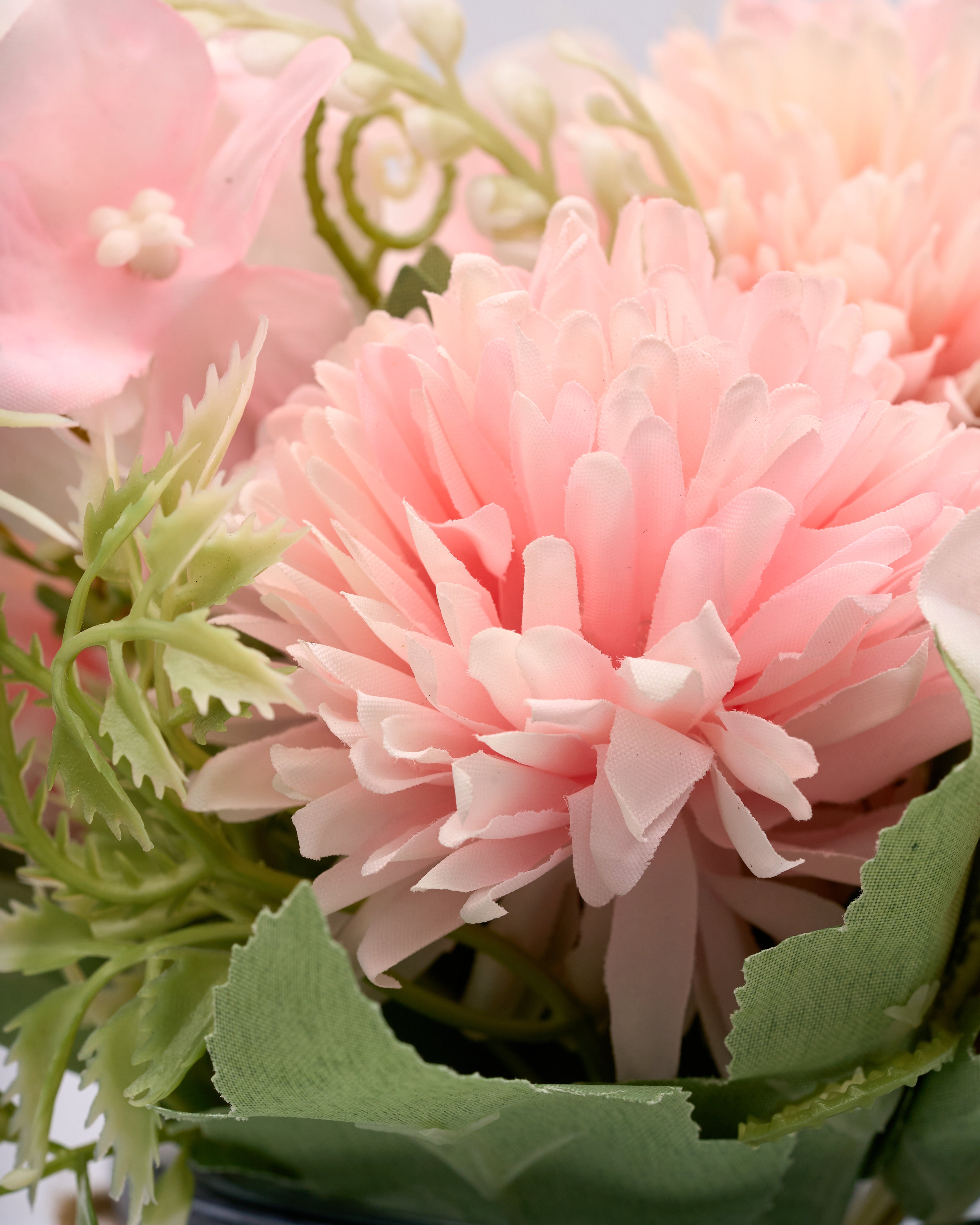 Close-up of a pink flower with green leaves in a bouquet