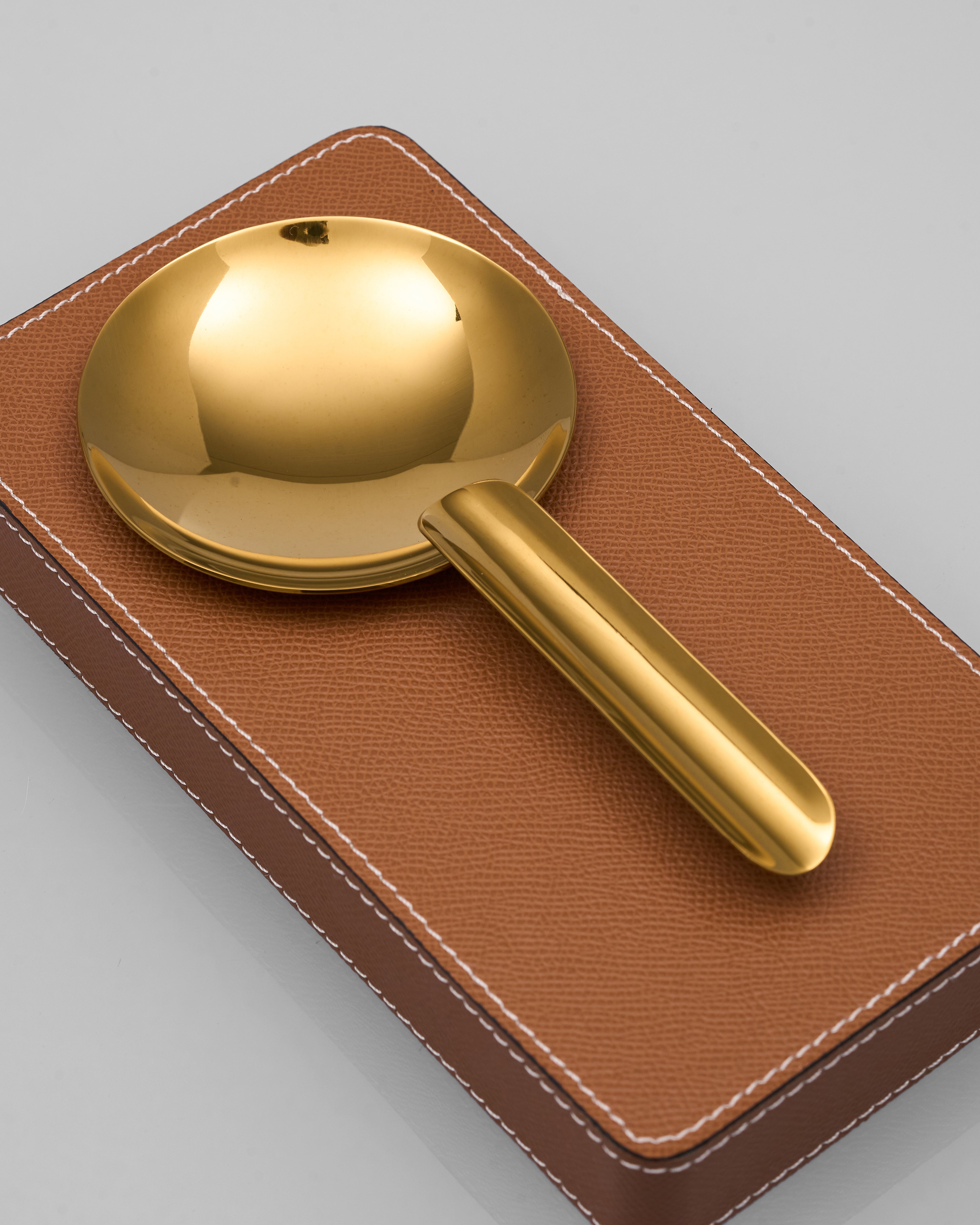 Gelo Leather Ashtray on a brown leather holder against a gray background