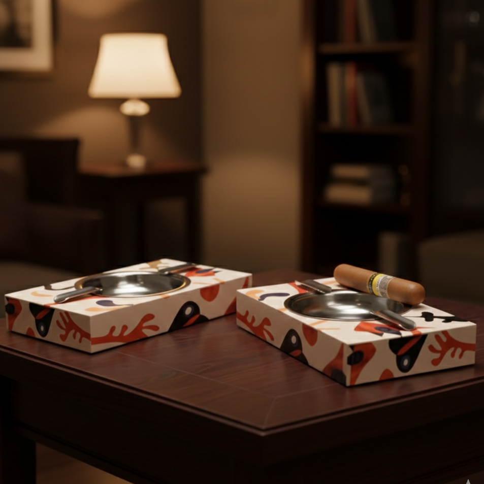 Two decorative ashtrays on a wooden table with a blurred background