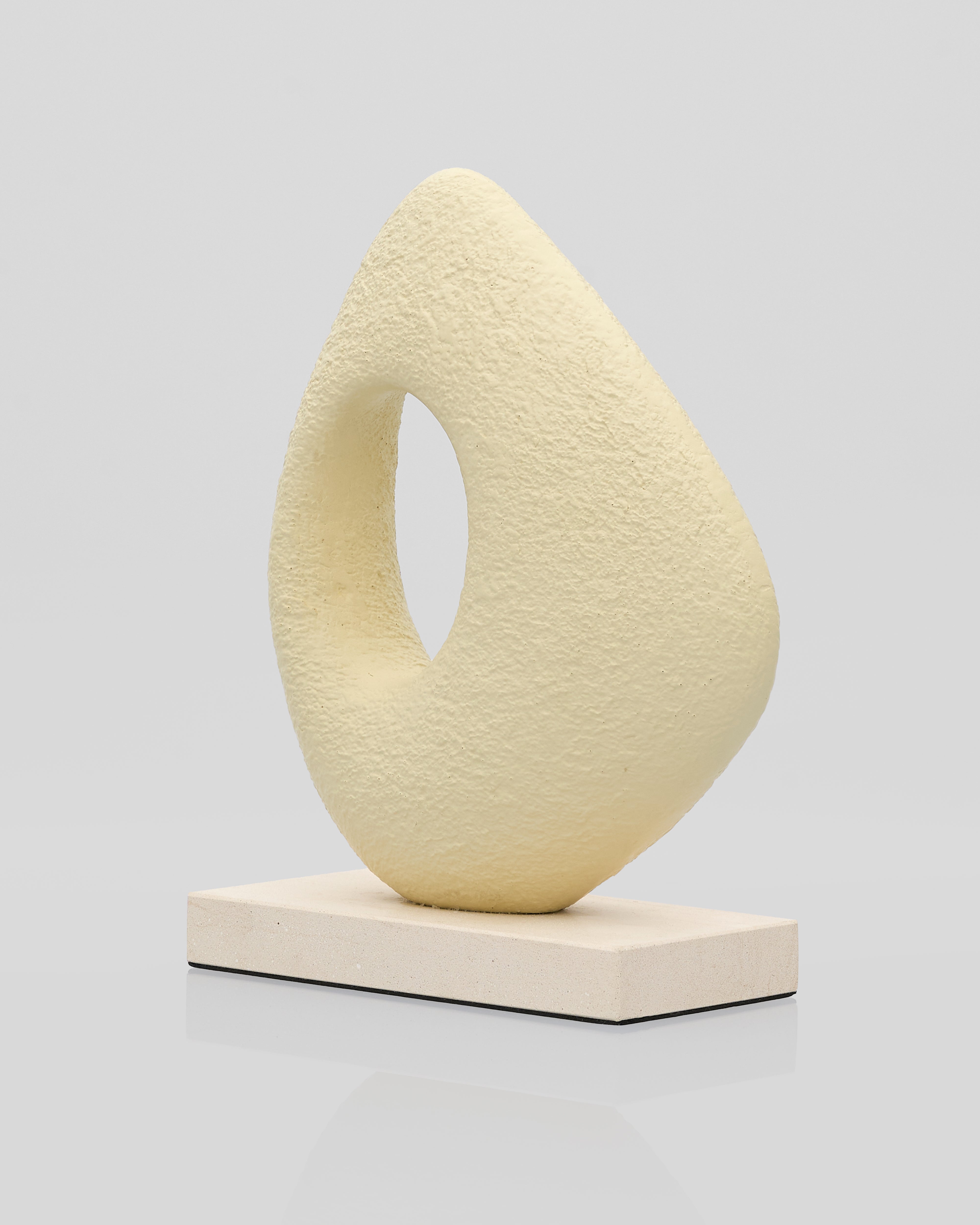 Abstract beige sculpture on a gray background
