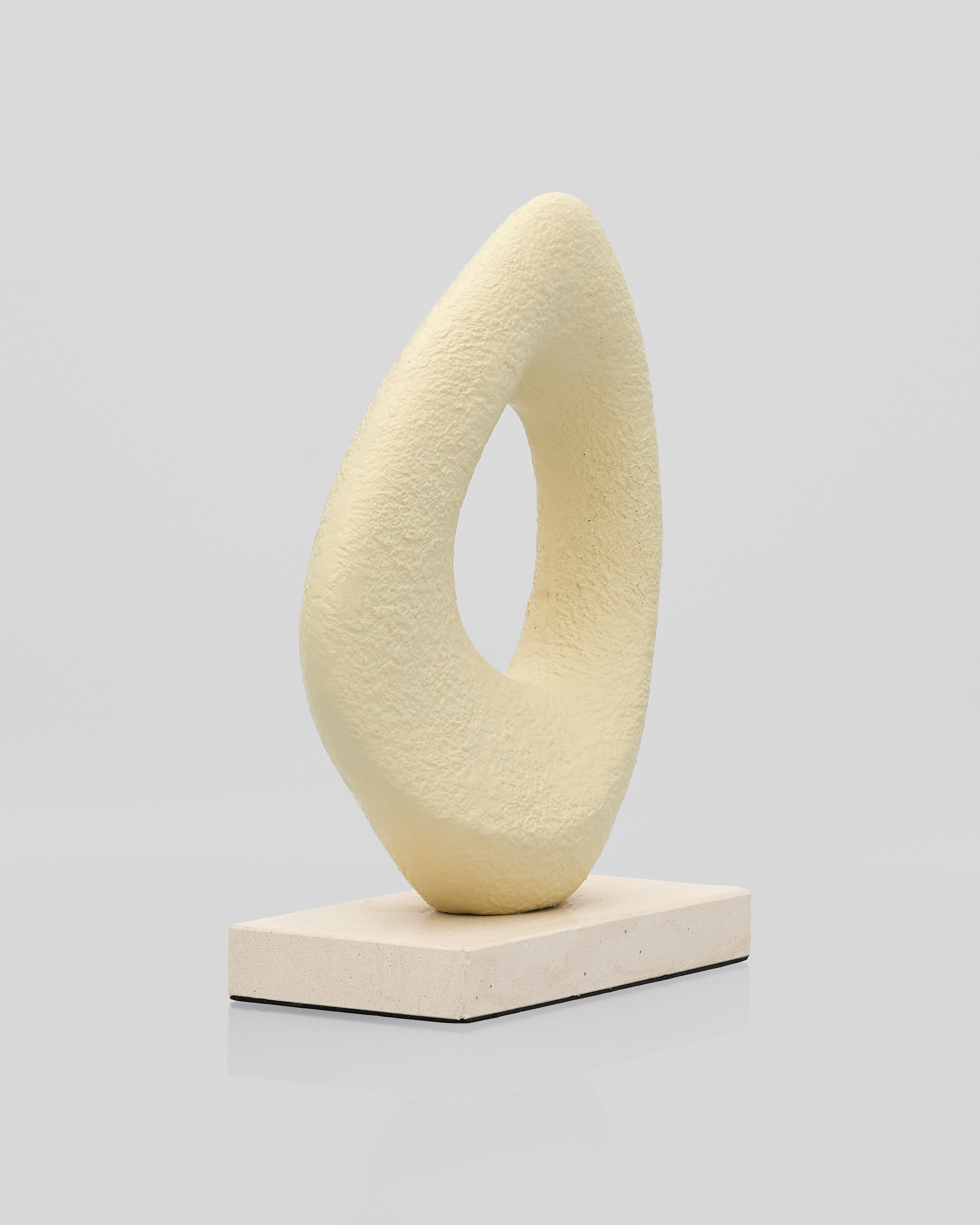 Abstract sculpture on a gray background mini beige color