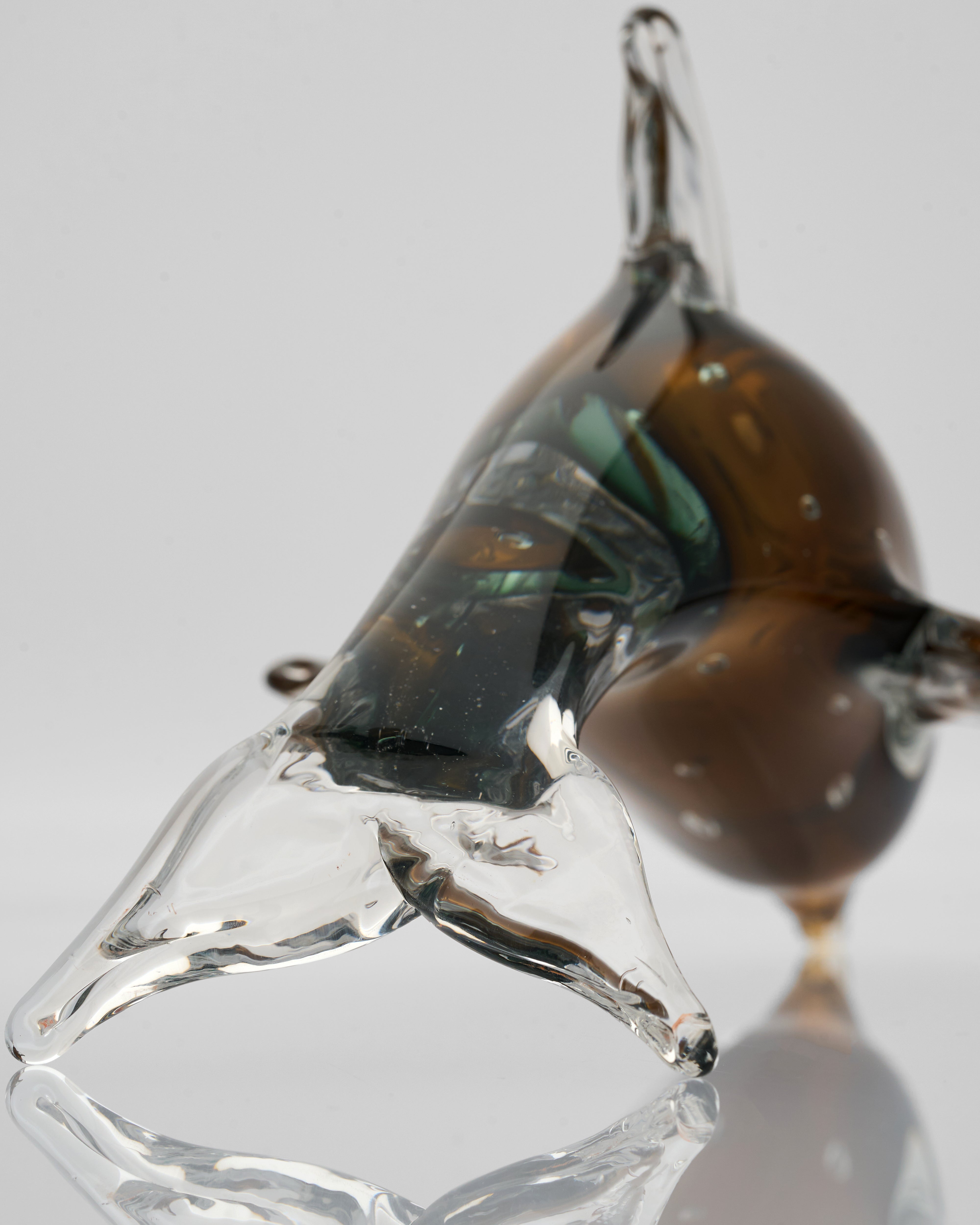 Glass pendant with brown and clear sections on a light gray background