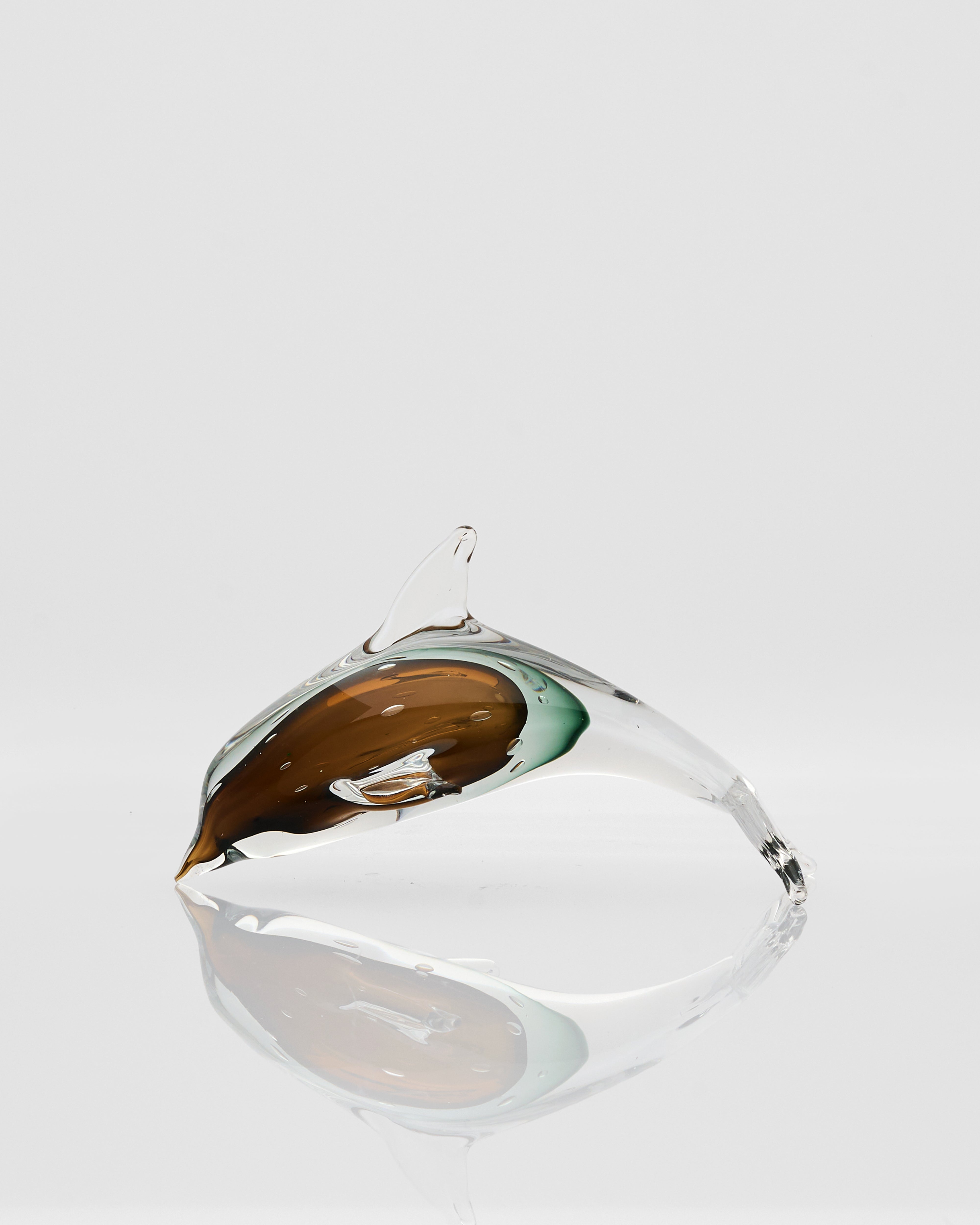 Glass sculpture with brown and green interior on a white background