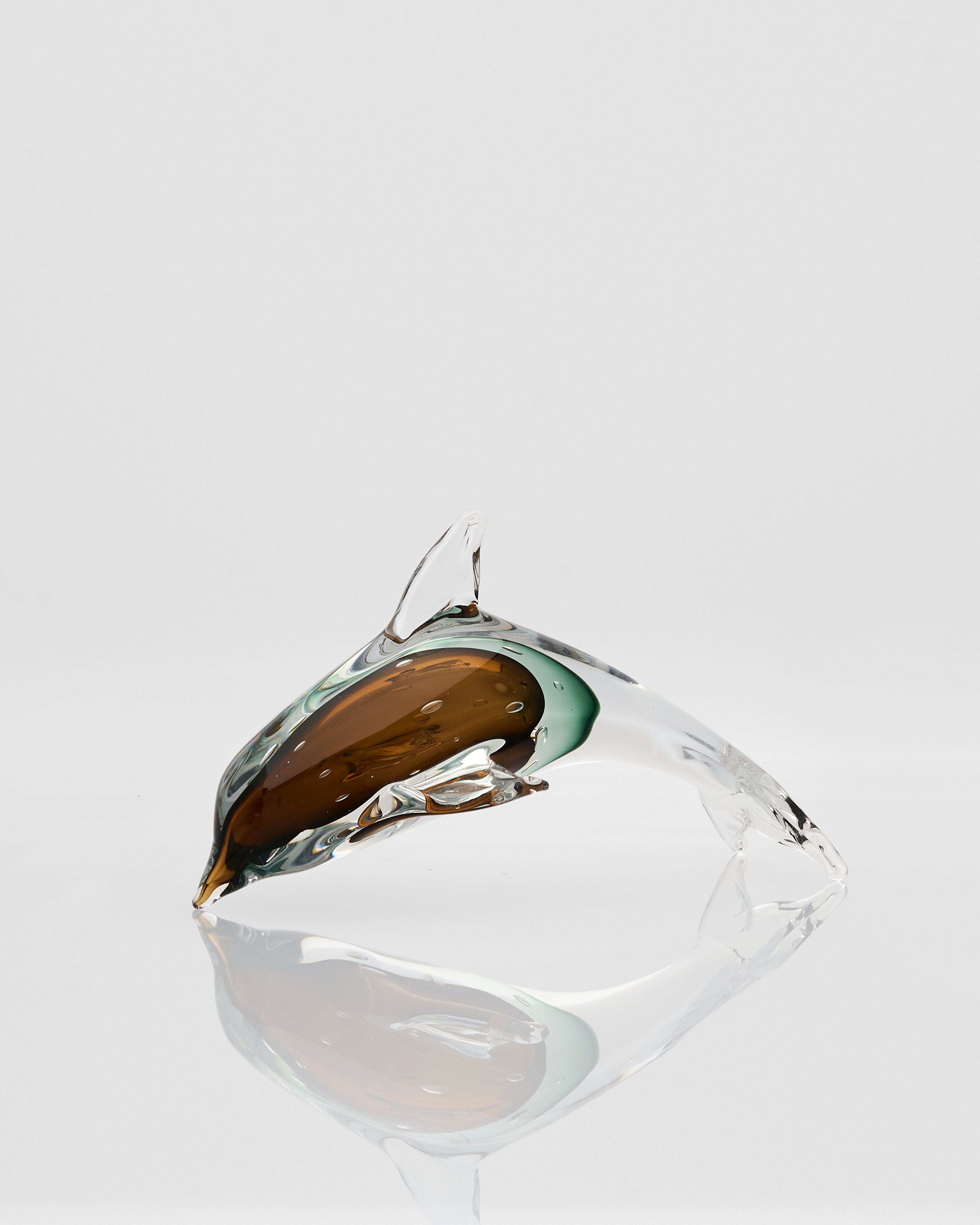 Clear glass object with a reflective surface on a white background