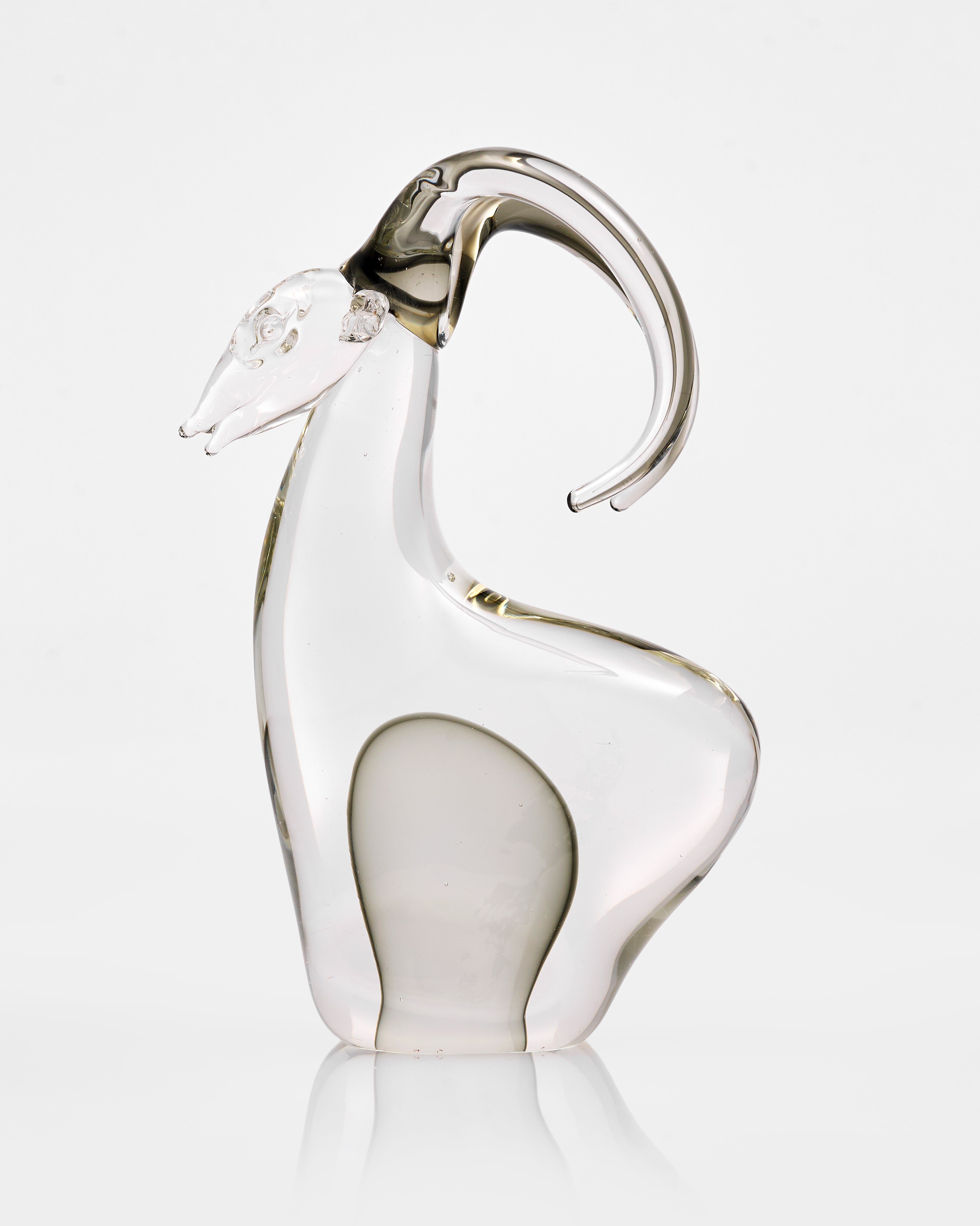 Glass sculpture of a goat on a white background
