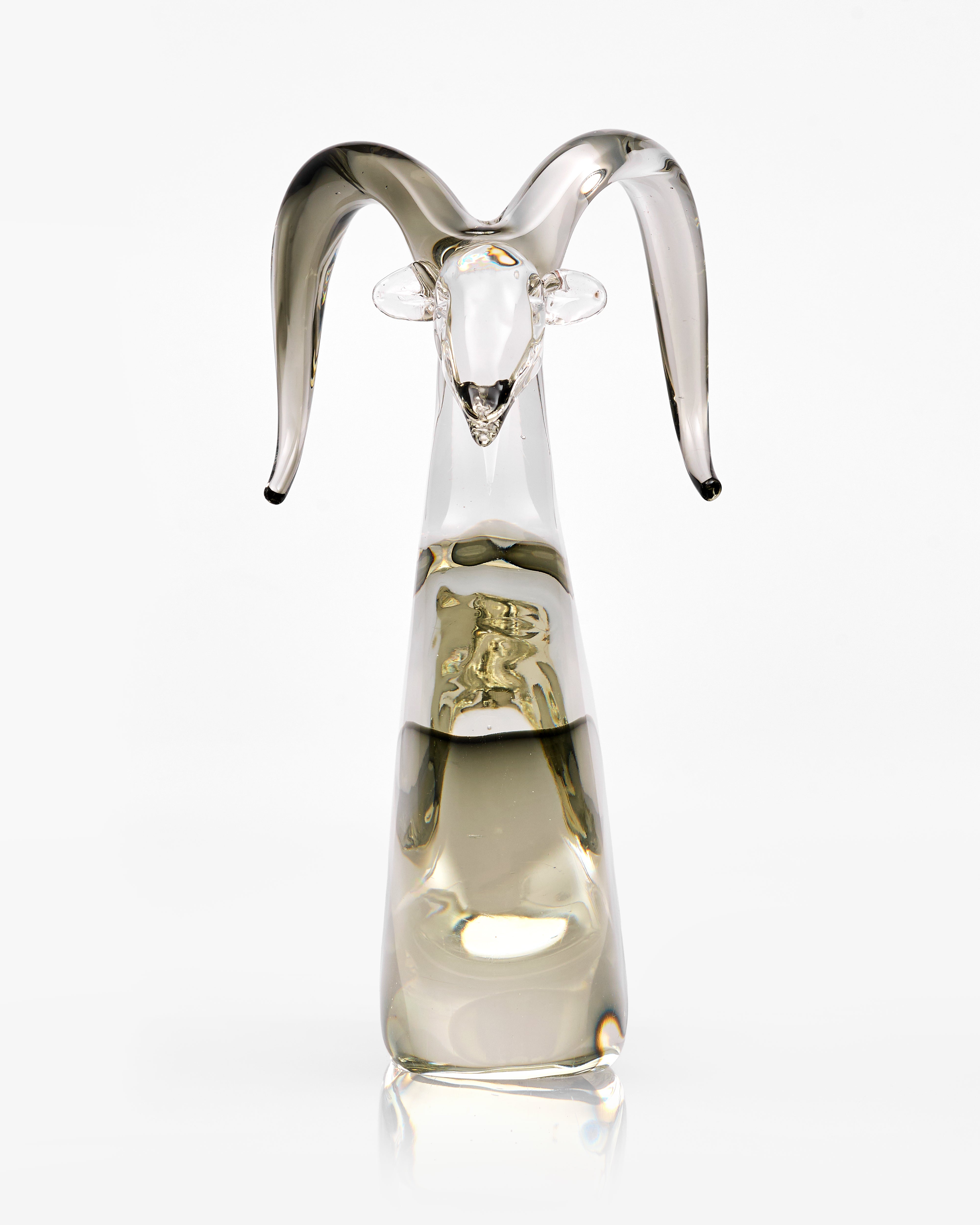 Glass sculpture of a goat with a white background