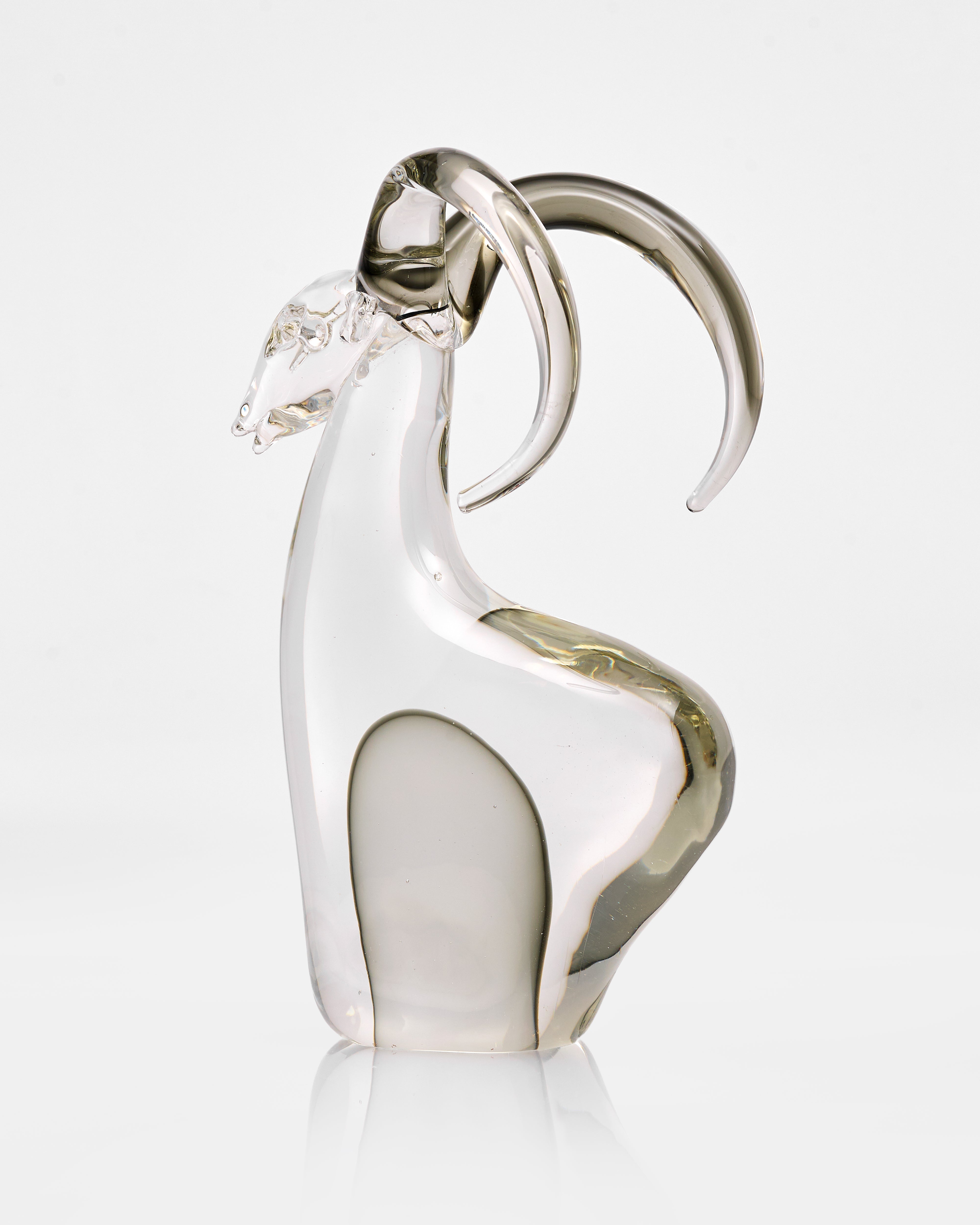 Glass sculpture of a swan on a white background