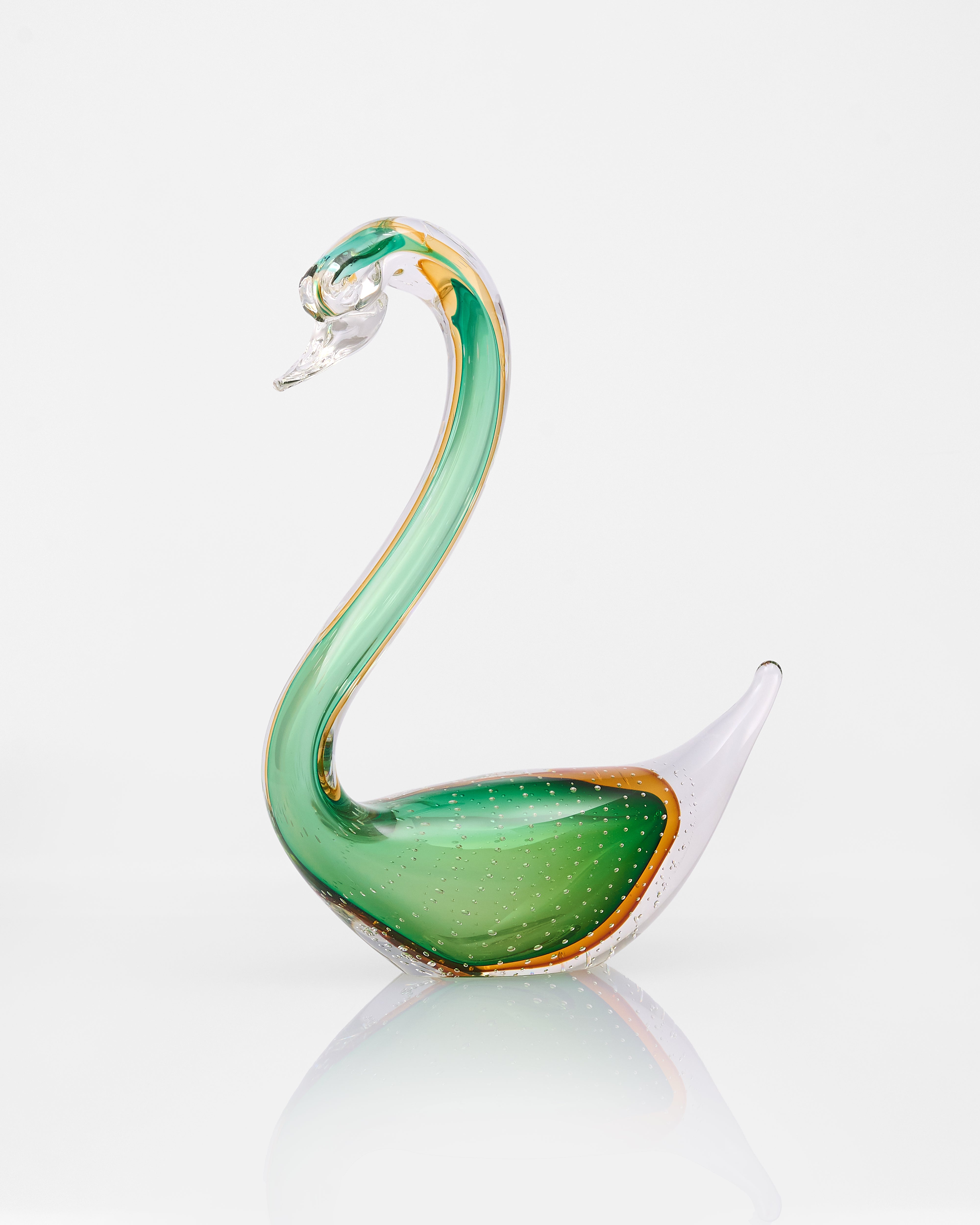 Glass swan ornament on a white background