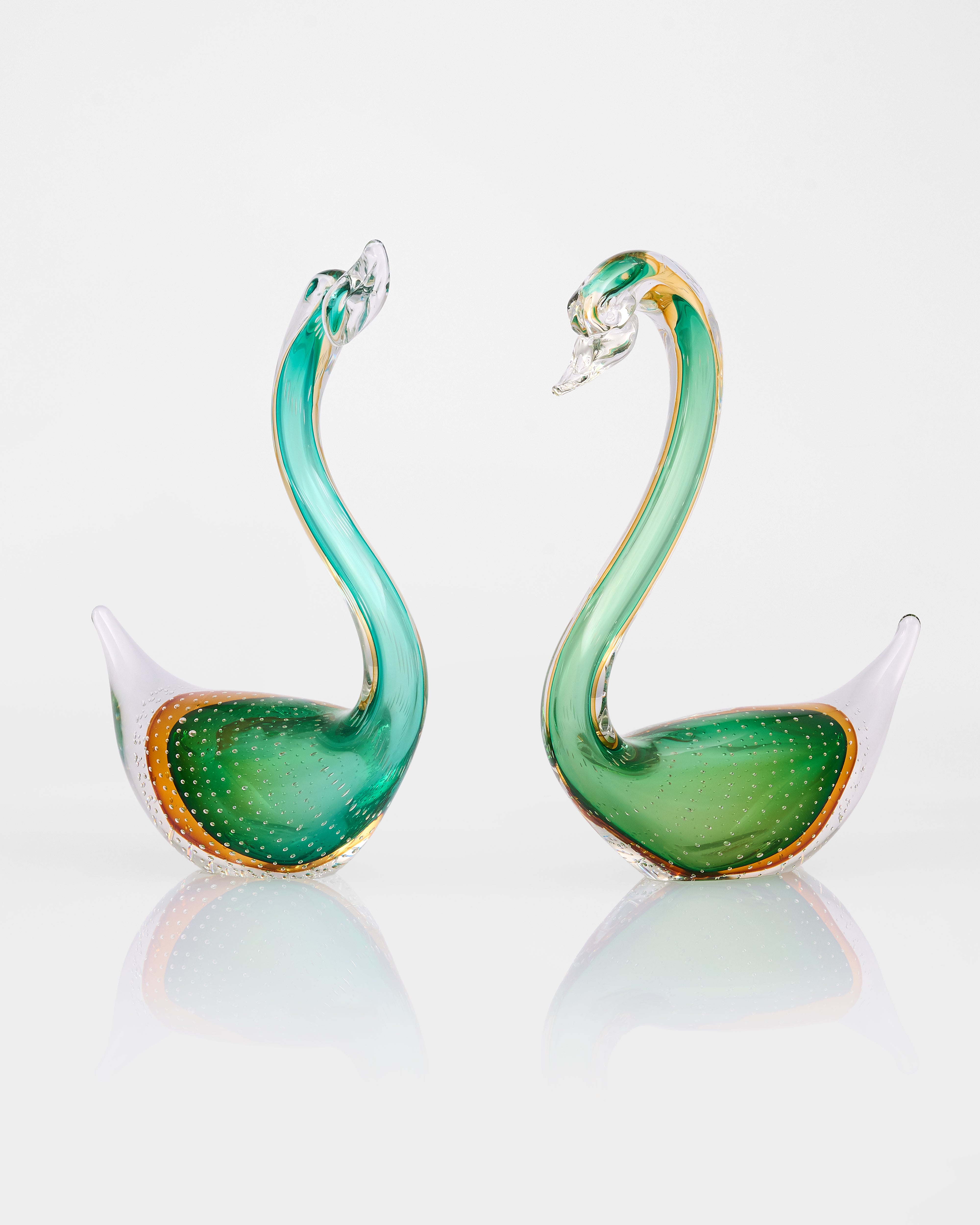 Green swan-shaped decors on a white background