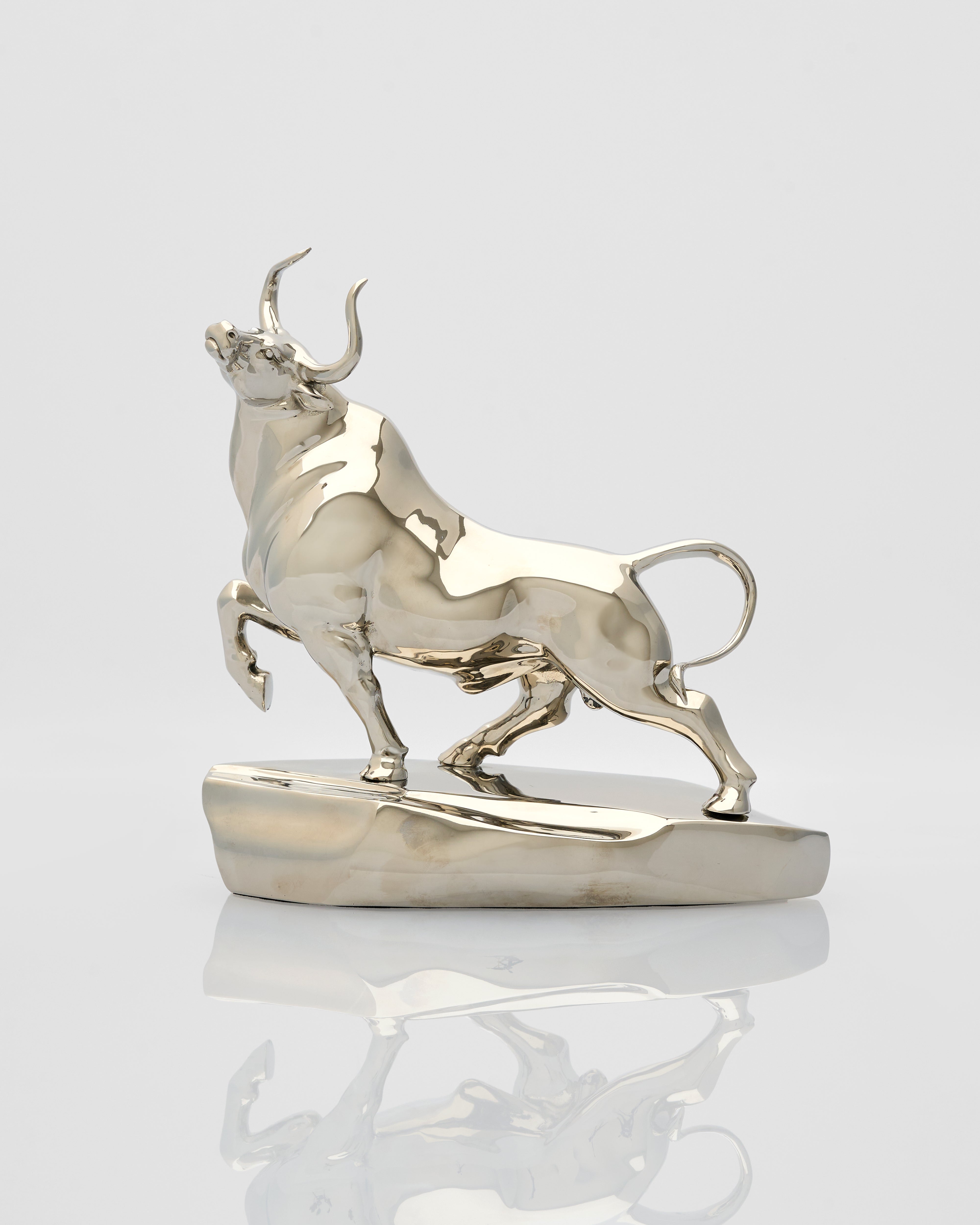 Metallic bull figurine on a white background
