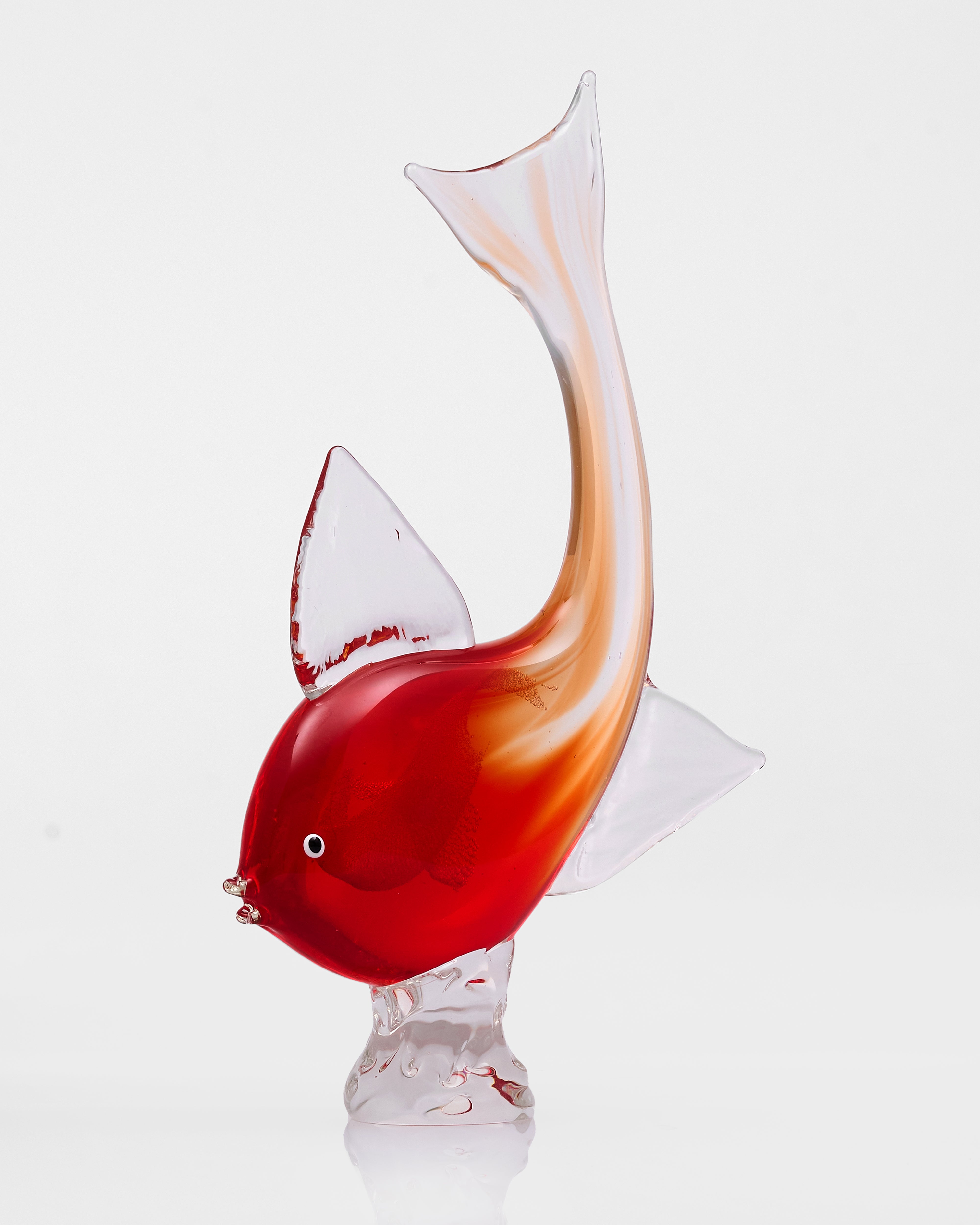 Glass fish sculpture with red and white colors on a white background