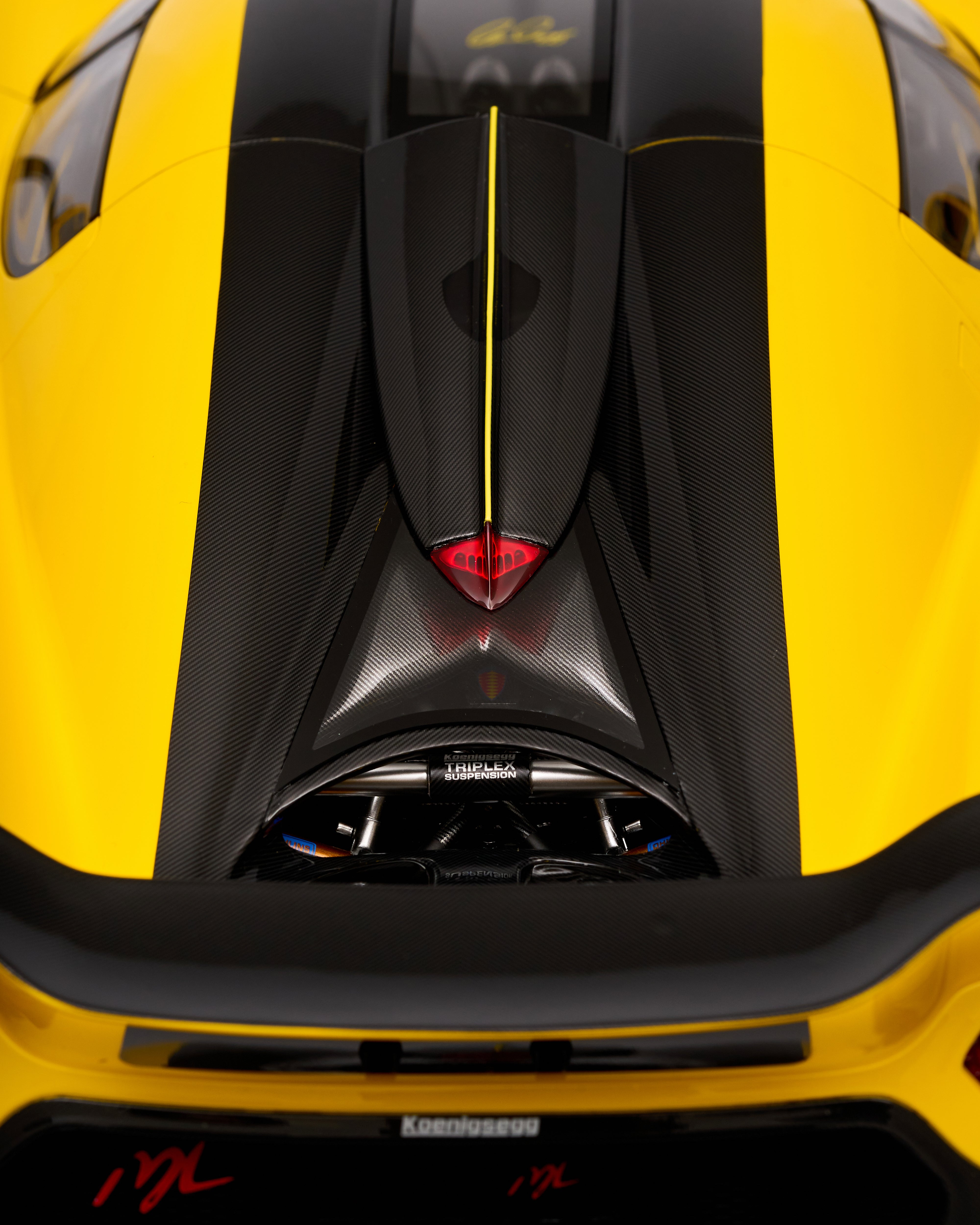 Close-up of a yellow and black sports car with a prominent front grille.