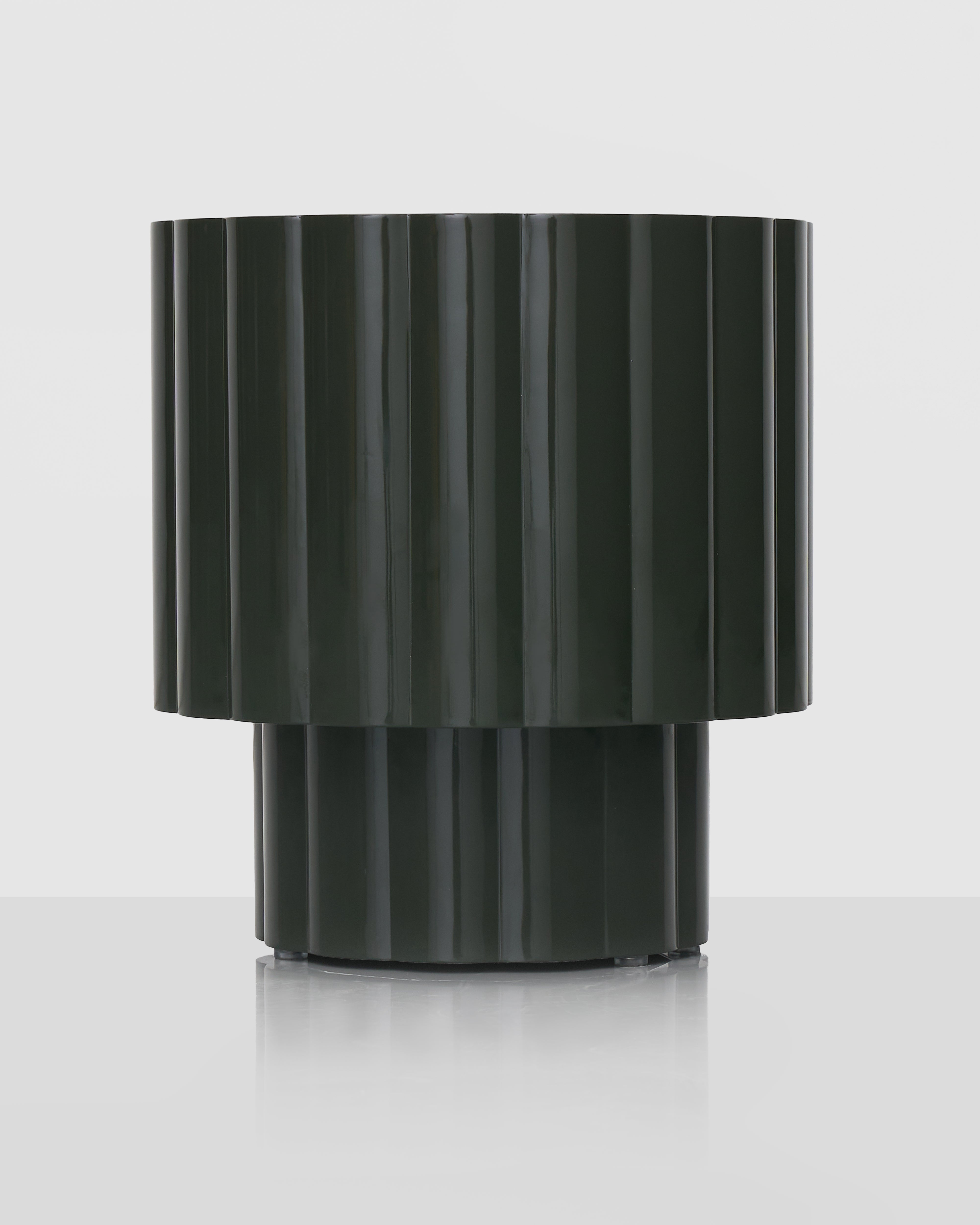 Black ribbed cylindrical vase on a white background