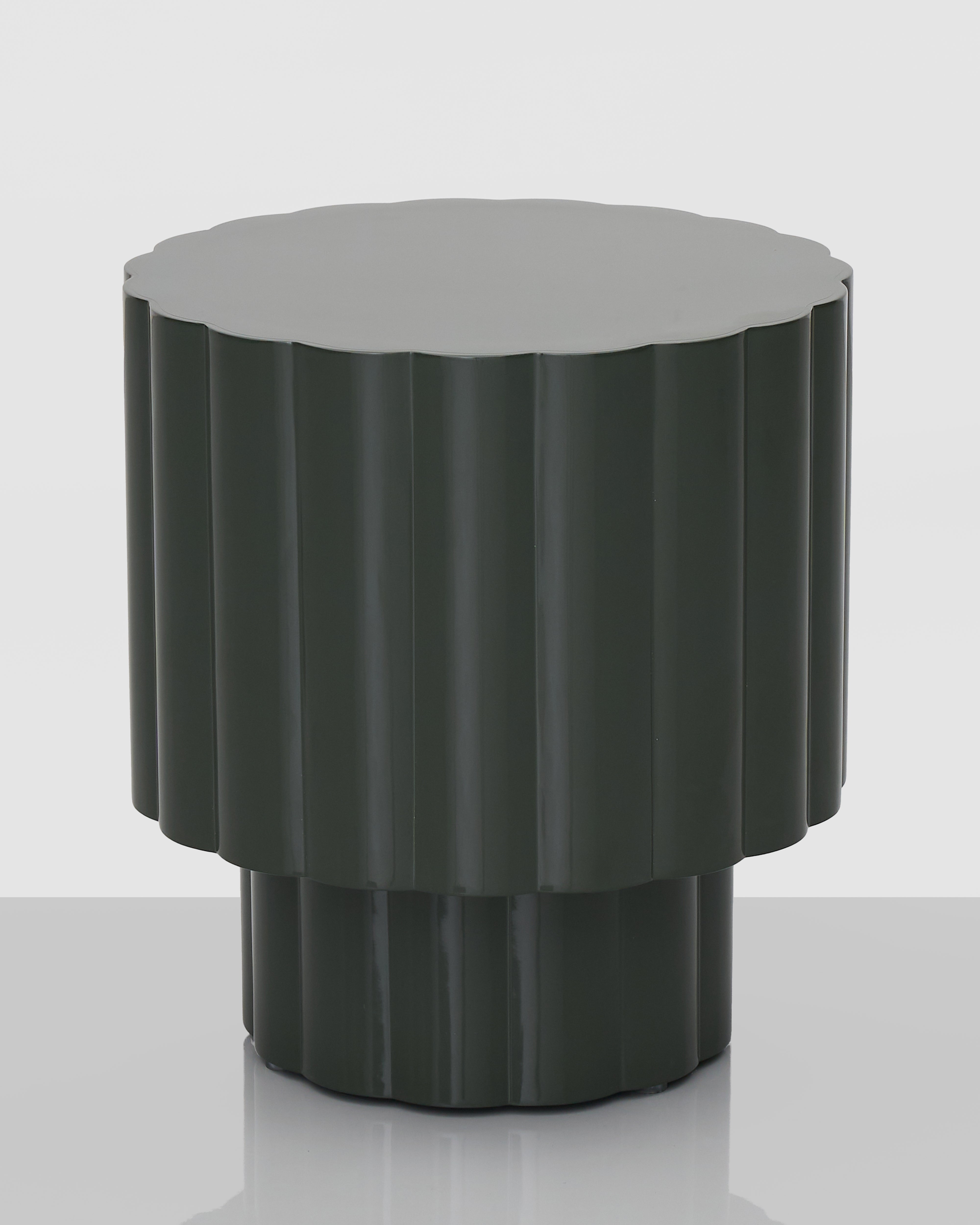 Dark gray side table with textured cylindrical design on a white background
