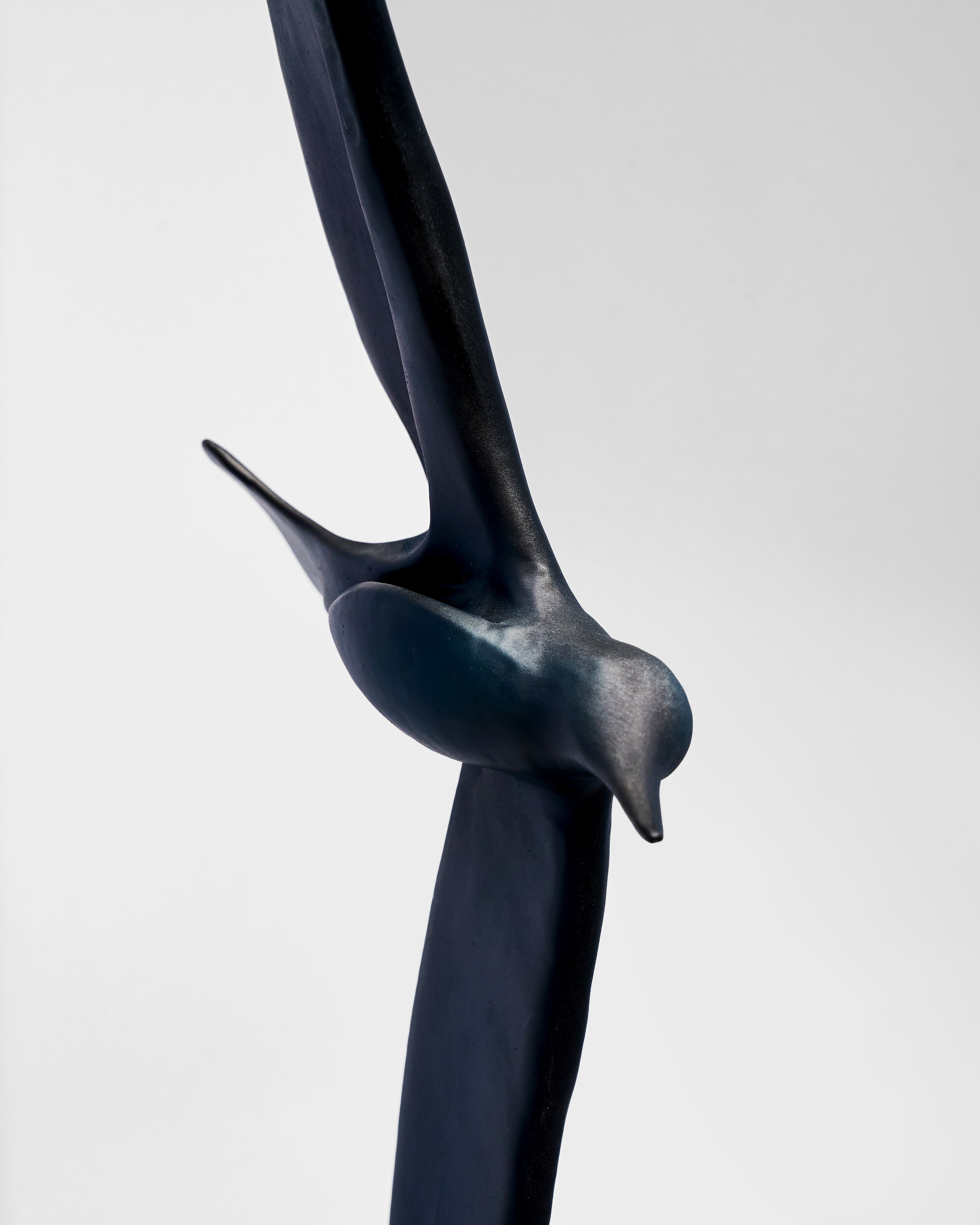 Black bird sculpture on a white background