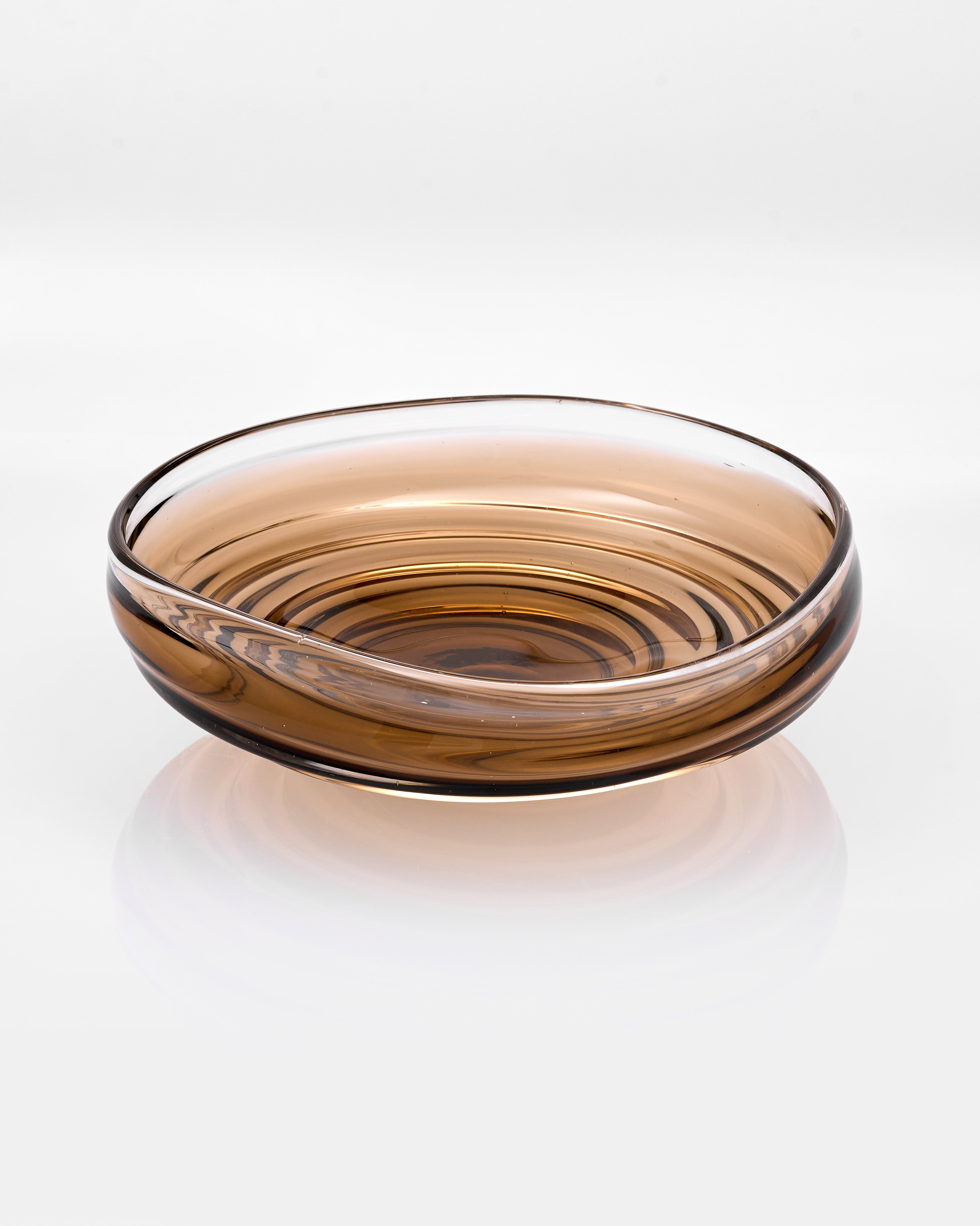 Clear glass bowl with brown tint on a white background