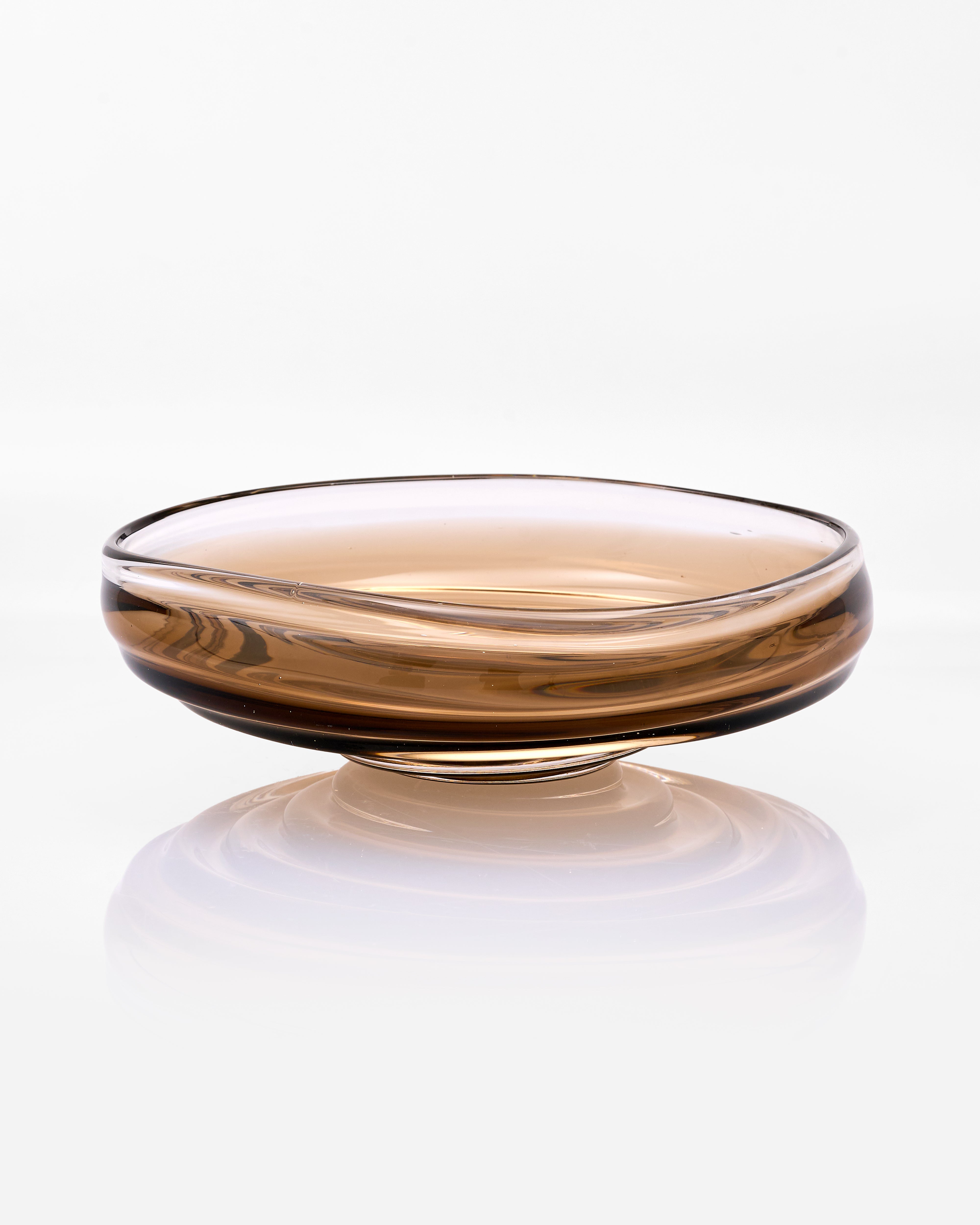 Glass bowl with a reflective surface on a white background