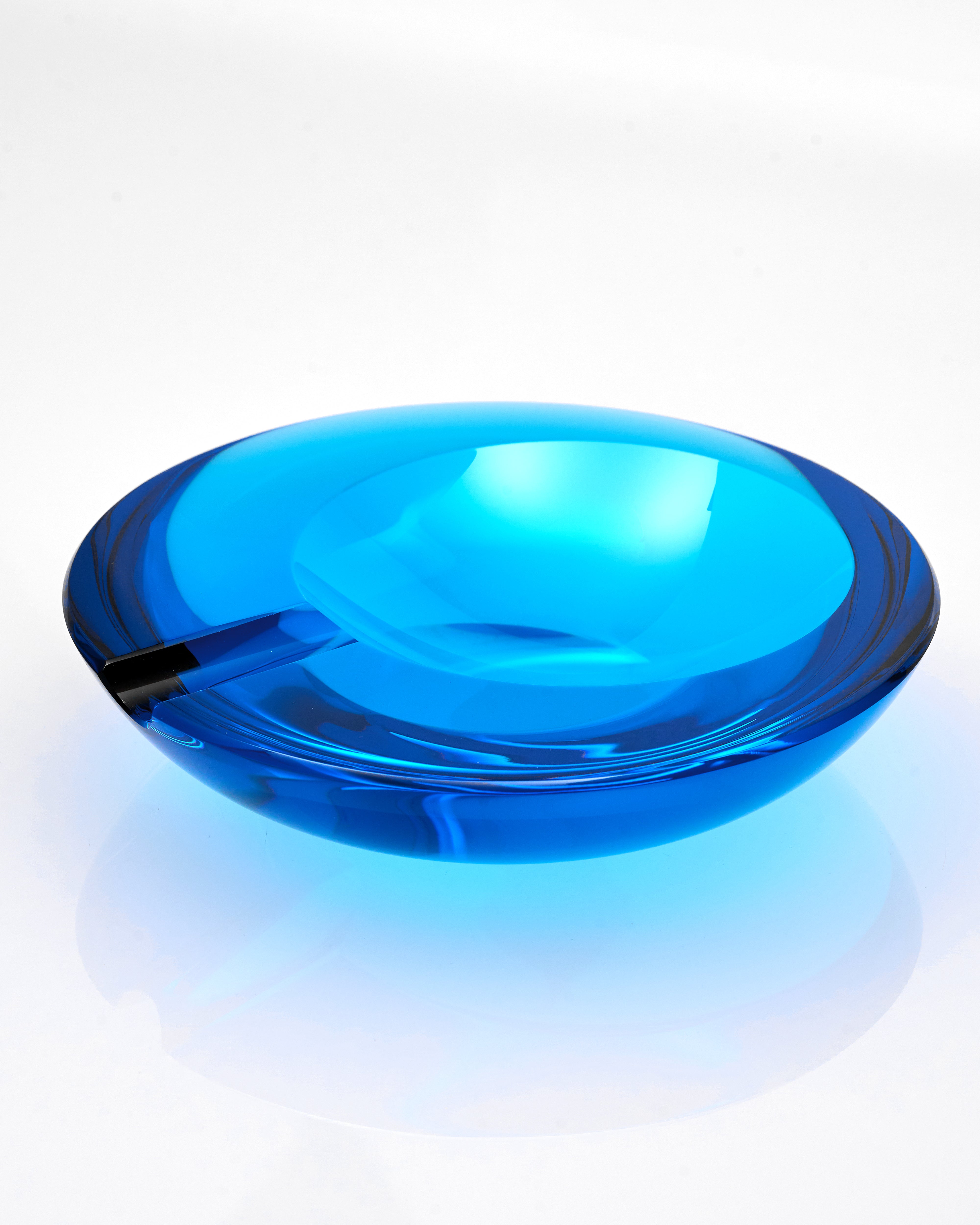 Blue glass ashtray on a white background